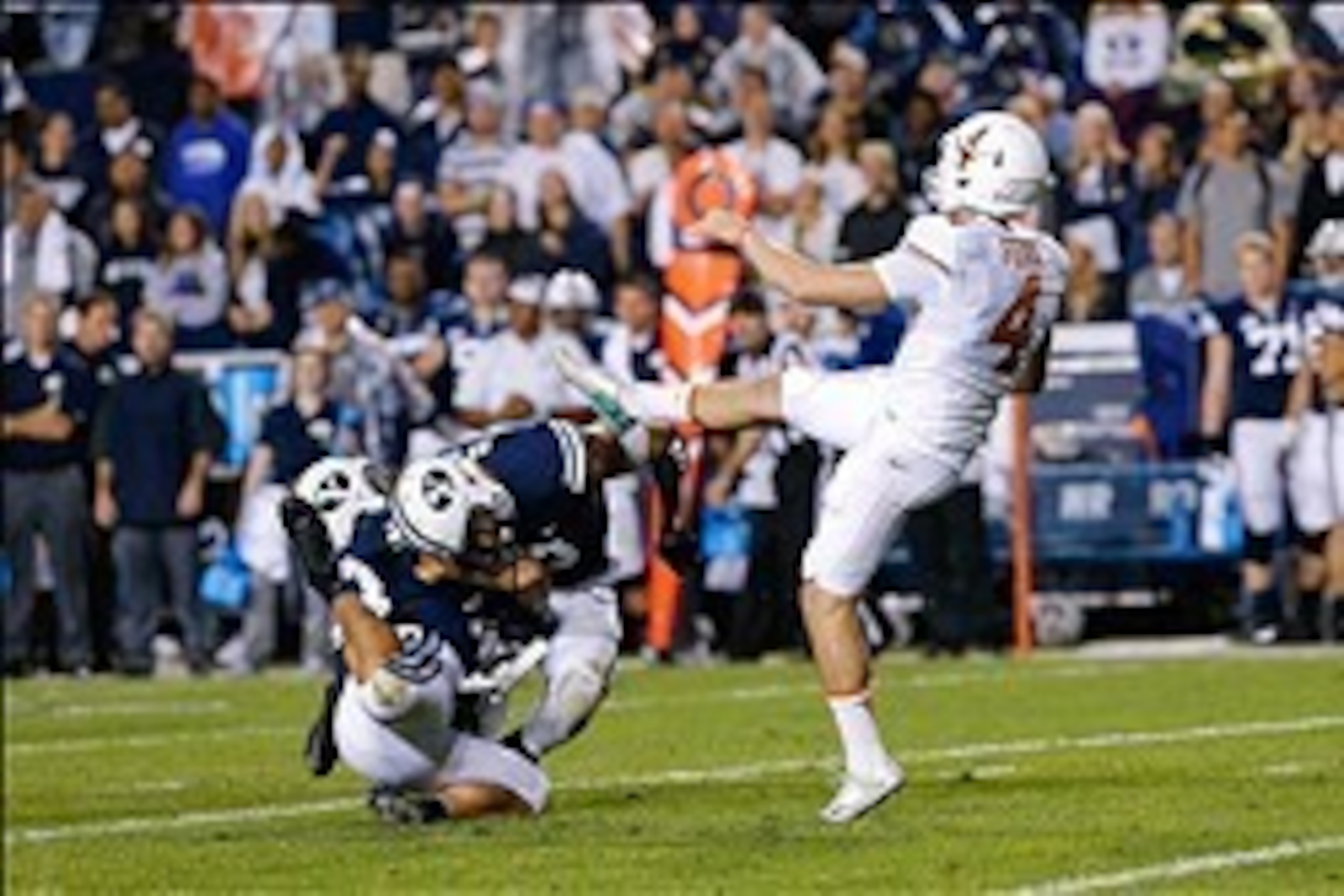 Sep 7, 2013; Provo, UT, USA; Brigham Young Cougars linebacker Kyle Van Noy (3) and Brigham Young Cougars linebacker Jherremya Leuta-Douyere (43) collide as Texas Longhorns kicker Anthony Fera (4) kicks the ball down the field at Lavell Edwards Stadium. Ma