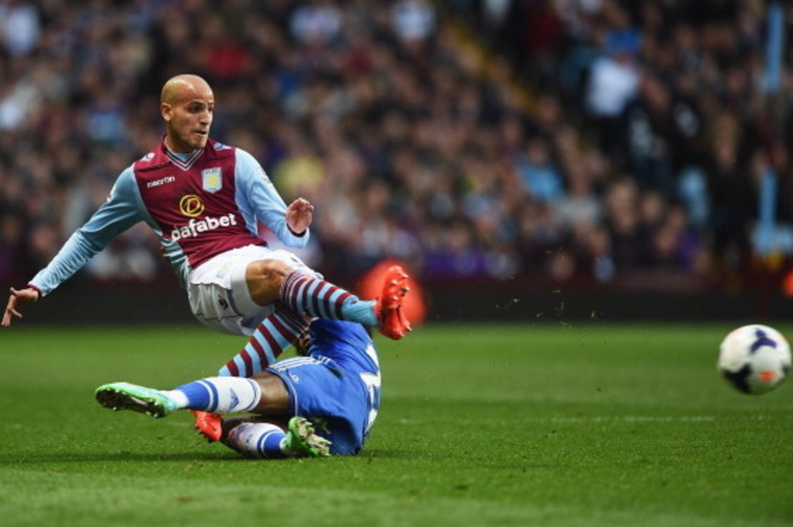 BIRMINGHAM, ENGLAND - MARCH 15:  Willian of Chelsea fouls Karim El Ahmadi of Aston Villa and is booked during the Barclays Premier League match between Aston Villa and Chelsea at Villa Park on March 15, 2014 in Birmingham, England.  (Photo by Michael Rega