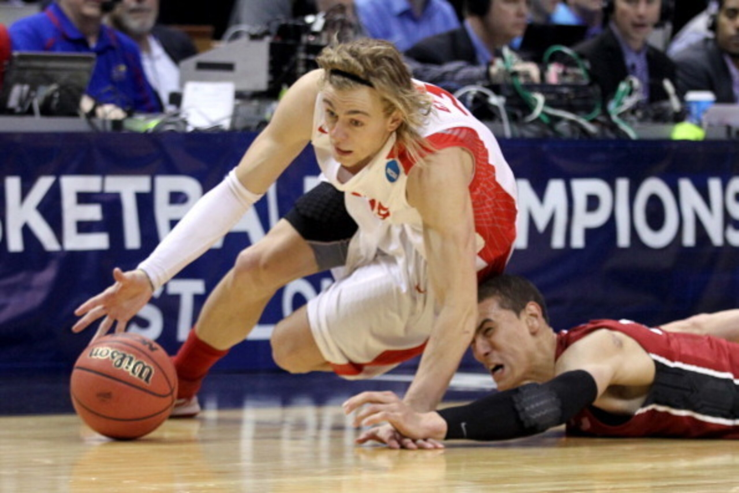 ST LOUIS, MO - MARCH 21:  Hugh Greenwood #3 of the New Mexico Lobos slides to grab a loose ball against Dwight Powell #33 of the Stanford Cardinal in the second half during the second round of the 2014 NCAA Men's Basketball Tournament at Scottrade Center 