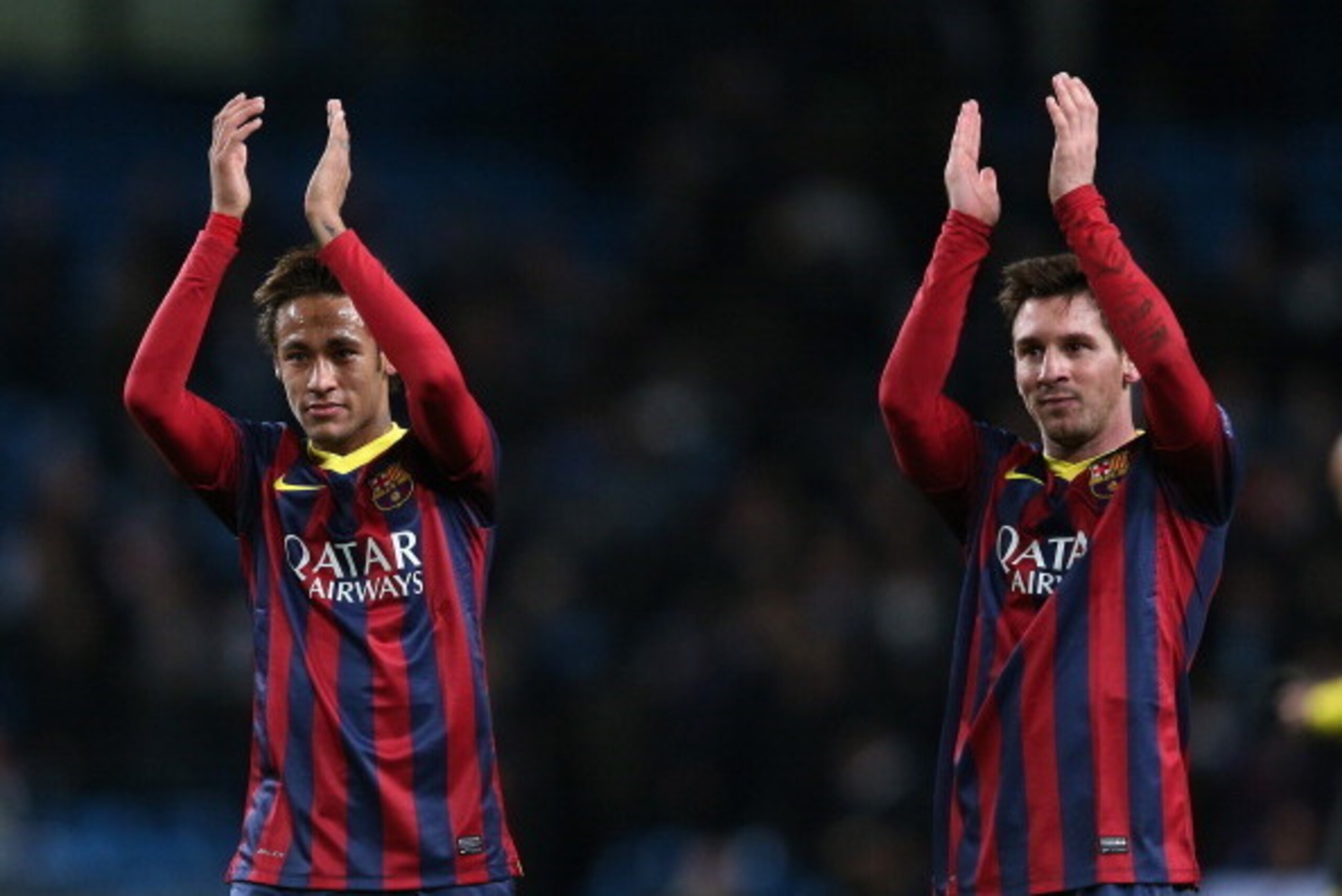 MANCHESTER, ENGLAND - FEBRUARY 18:  Neymar (L) and Lionel Messi of Barcelona salute the crowd following their team's victory at the end of the UEFA Champions League Round of 16 first leg match between Manchester City and Barcelona at the Etihad Stadium on
