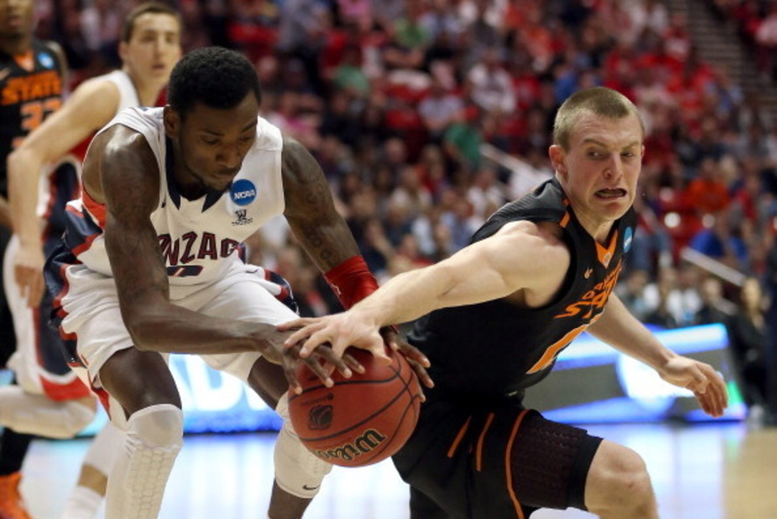 SAN DIEGO, CA - MARCH 21:  Gerard Coleman #0 of the Gonzaga Bulldogs and Phil Forte #13 of the Oklahoma State Cowboys go for the loose ball during the second round of the 2014 NCAA Men's Basketball Tournament at Viejas Arena on March 21, 2014 in San Diego
