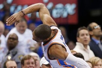 Westbrook angrily slams his hand on the scorer's table after getting injured against the Rockets.
