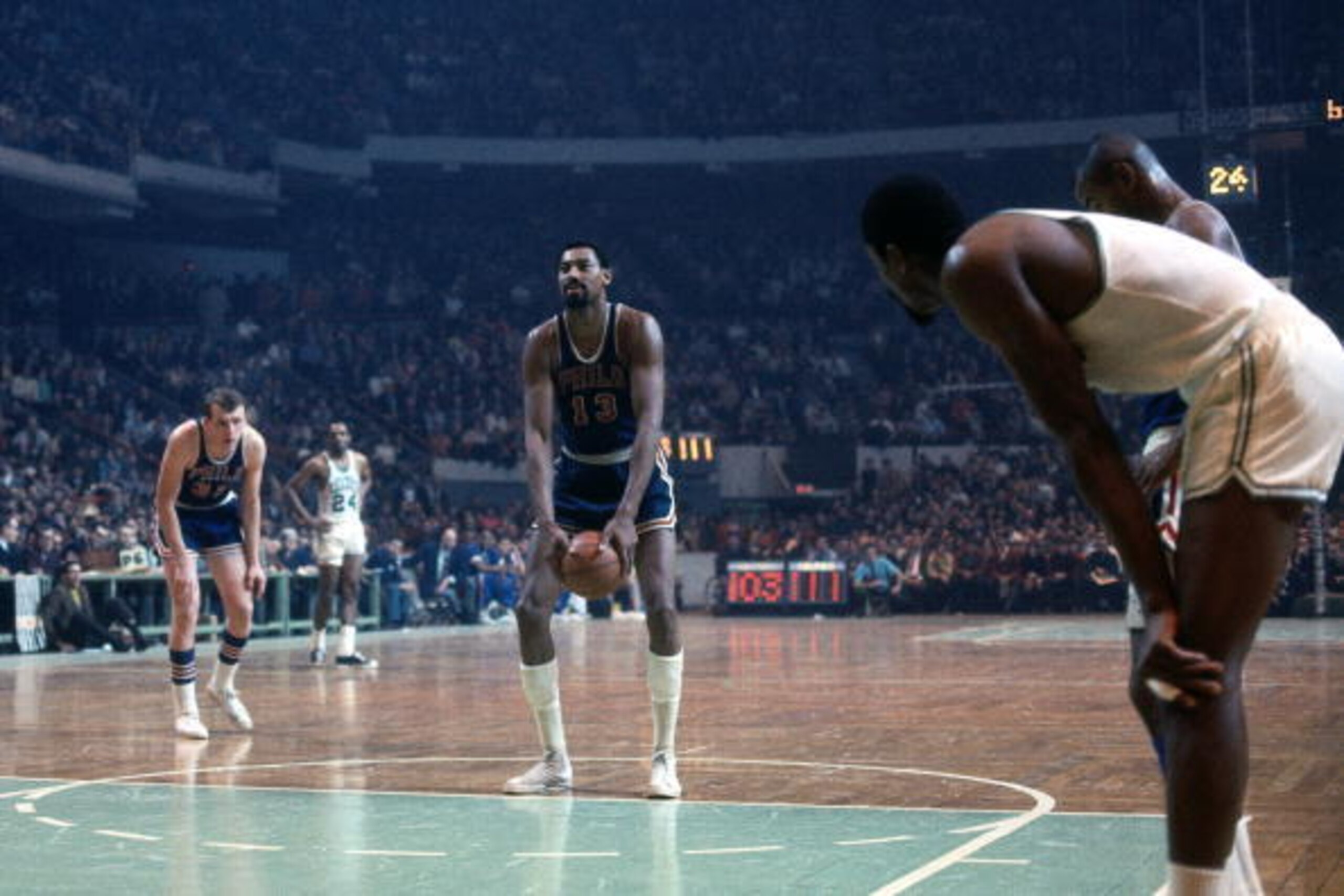 BOSTON - 1968:  Wilt Chamberlain #13 of the Philadelphia 76ers shoots a free throw against the Boston Celtics during a game played in 1968 at the Boston Garden in Boston, Massachusetts. NOTE TO USER: User expressly acknowledges and agrees that, by downloa