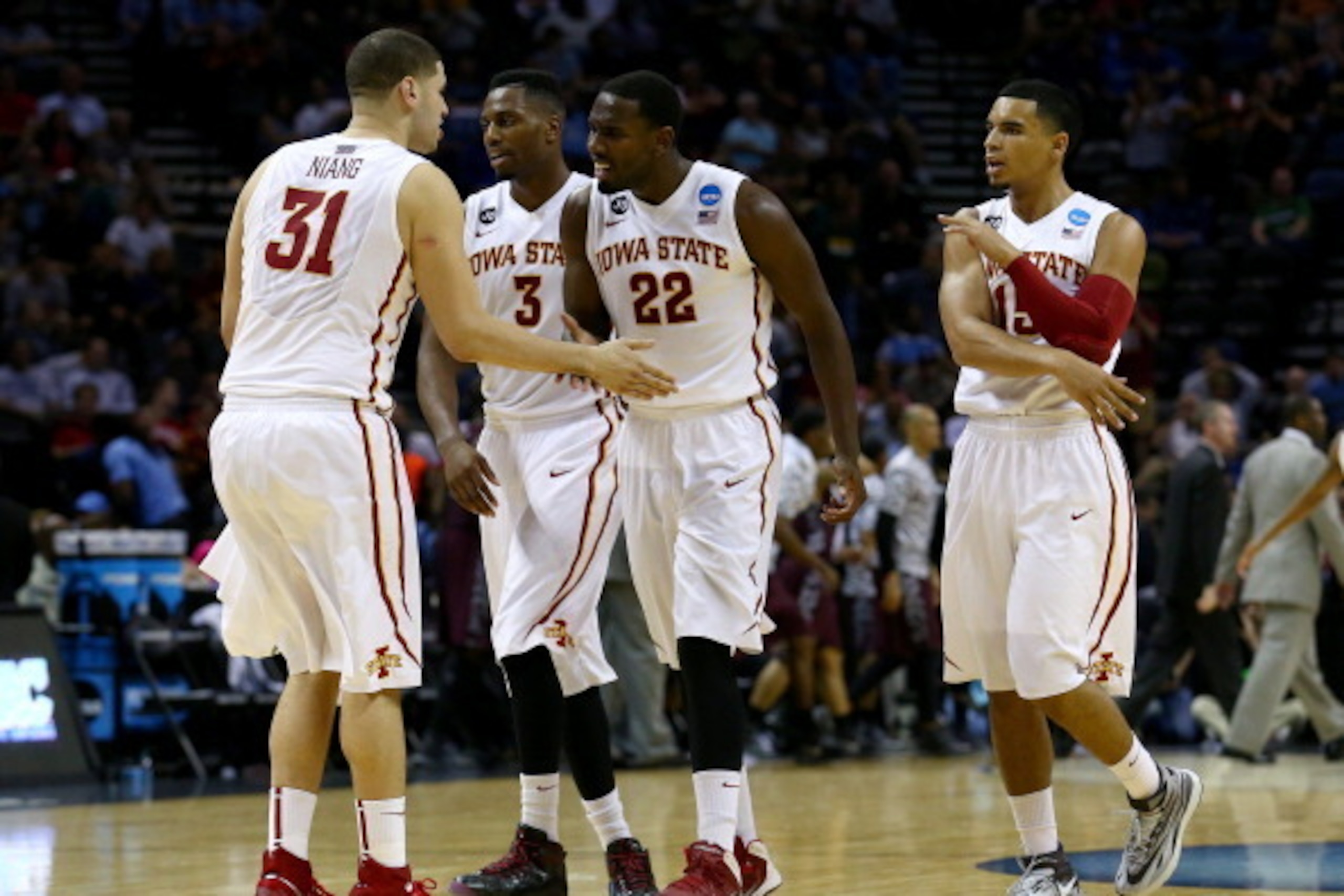 SAN ANTONIO, TX - MARCH 21: Georges Niang #31, Melvin Ejim #3, Dustin Hogue #22 and Naz Long #15 of the Iowa State Cyclones celebrate during the first half against the North Carolina Central Eagles during the second round of the 2014 NCAA Men's Basketball