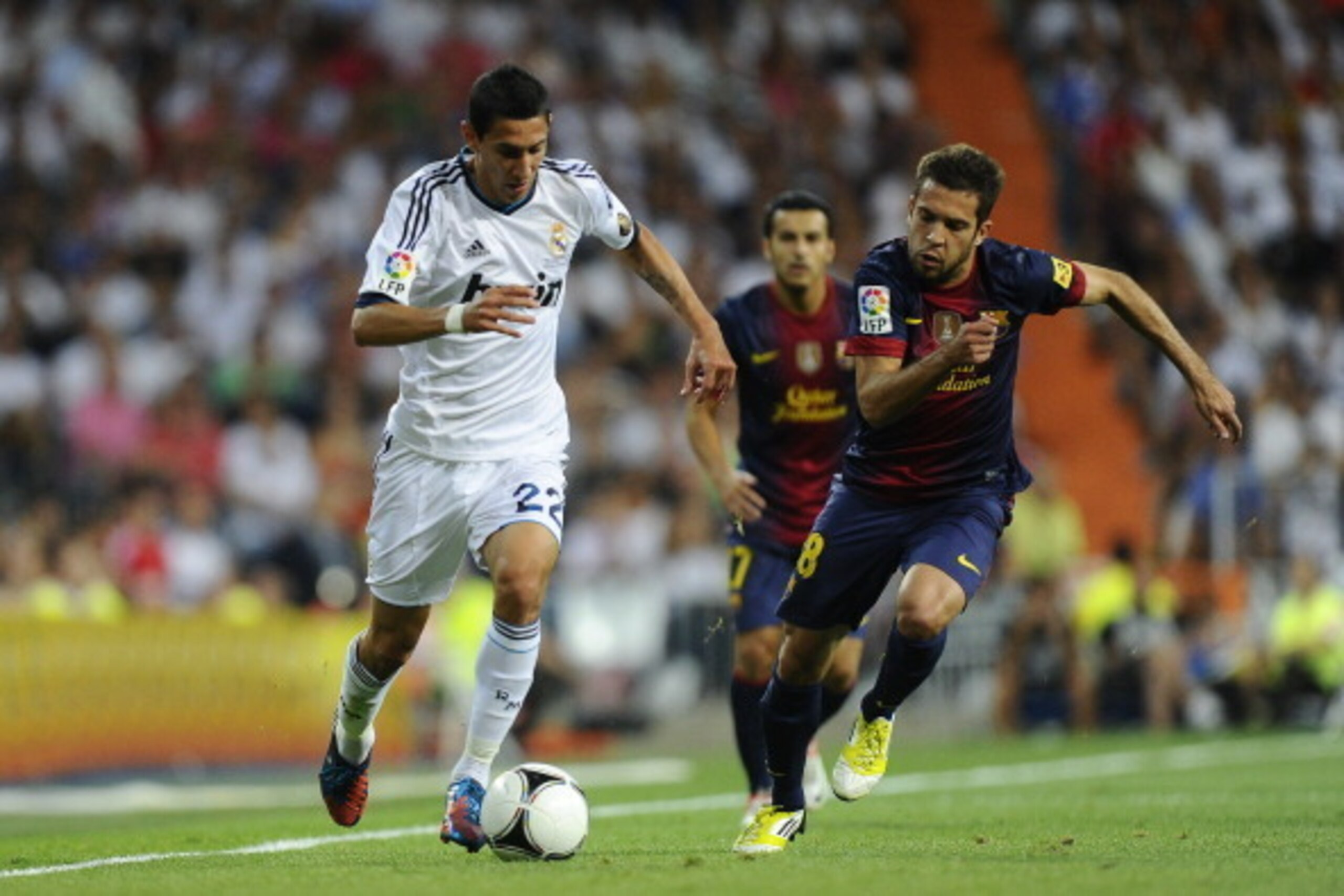 MADRID, SPAIN - AUGUST 29:  Angel Di Maria of Real Madrid CF (L) duels for the ball with Jordi Alba of FC Barcelona during the Super Cup second leg match betwen Real Madrid and FC Barcelona at Estadio Santiago Bernabeu on August 29, 2012 in Madrid, Spain.