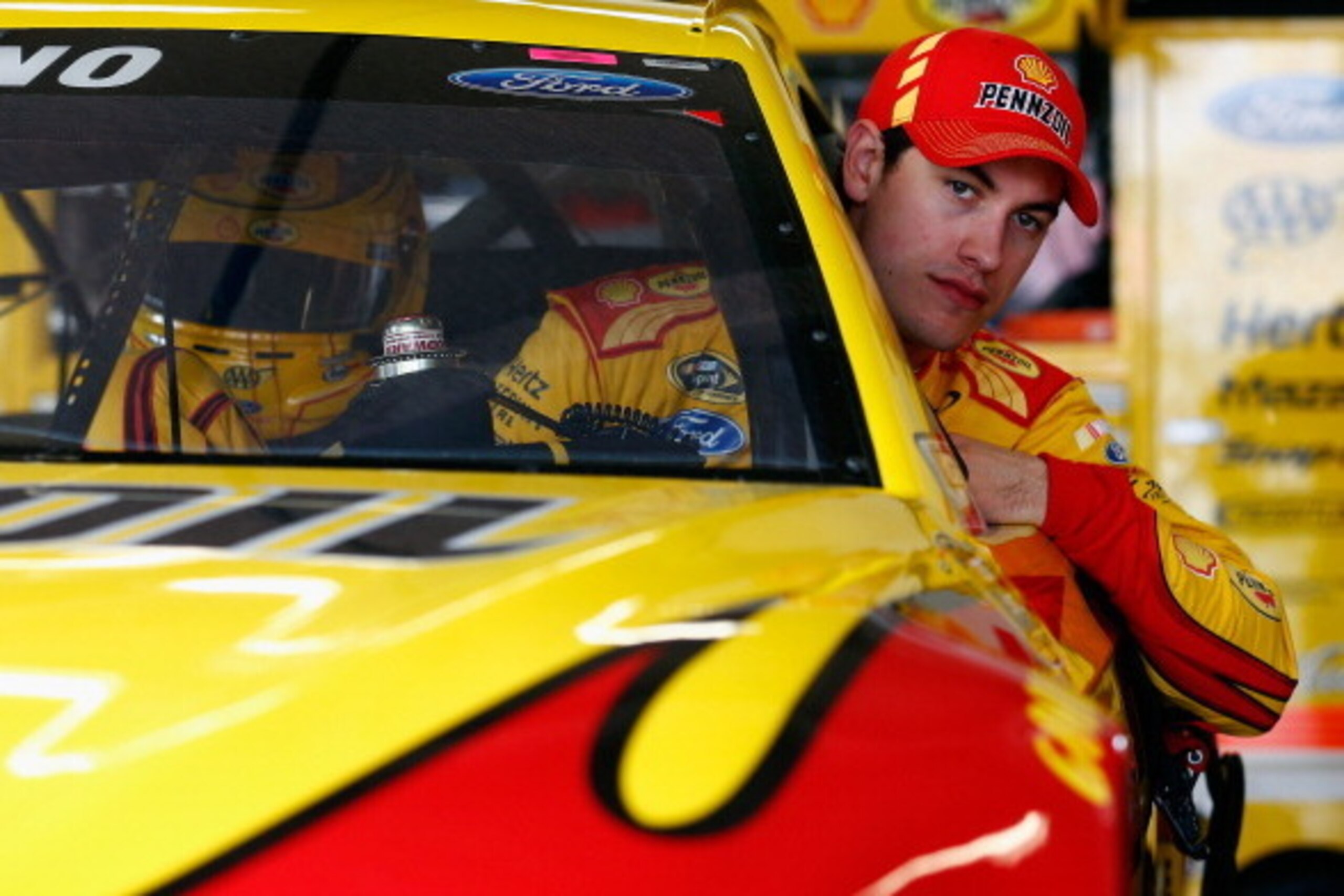 DAYTONA BEACH, FL - FEBRUARY 21:  Joey Logano, driver of the #22 Shell-Pennzoil Ford, climbs into his car in the garage area during practice for the NASCAR Sprint Cup Series Daytona 500 at Daytona International Speedway on February 21, 2014 in Daytona Bea