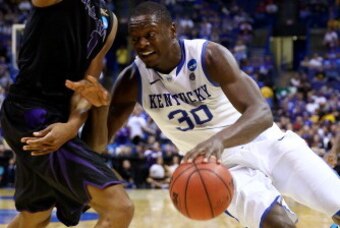 ST LOUIS, MO - MARCH 21: Julius Randle #30 of the Kentucky Wildcats drives to the basket as Shane Southwell #1 of the Kansas State Wildcats defends during the second round of the 2014 NCAA Men's Basketball Tournament at the Scottrade Center on March 21, 2