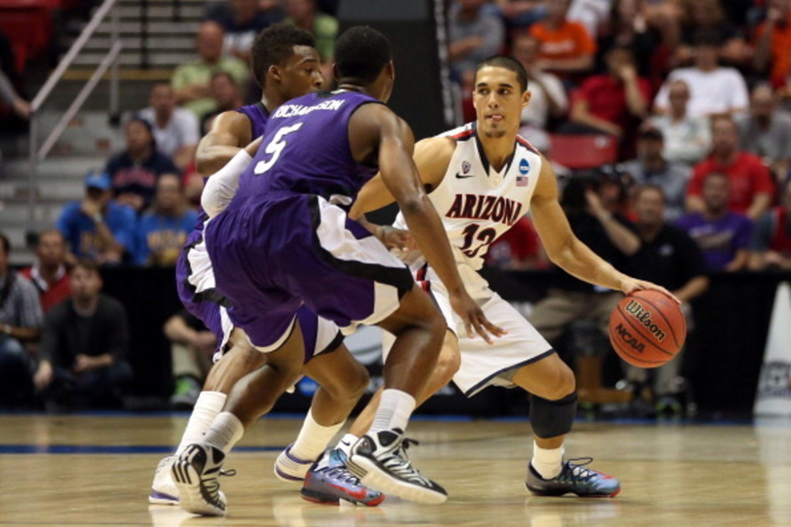 SAN DIEGO, CA - MARCH 21:  Nick Johnson #13 of the Arizona Wildcats is covered by Jordan Richardson #5 of the Weber State Wildcats during the second round of the 2014 NCAA Men's Basketball Tournament at Viejas Arena on March 21, 2014 in San Diego, Califor