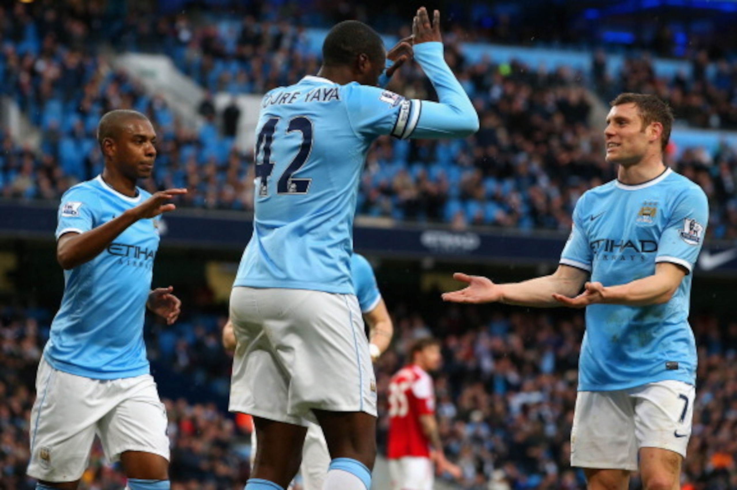 MANCHESTER, ENGLAND - MARCH 22:  Yaya Toure of Manchester City celebrates scoring the opening goal from the penalty spot d with James Milner of Manchester City (R) during the Barclays Premier League match between Manchester City and Fulham at Etihad Stadi