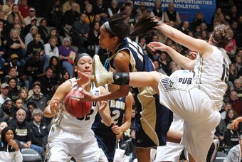 Mar 22, 2014; West Lafayette, IN, USA;  Akron Zips guard Anita Brown (15) battles for a rebound against  Purdue Boilermakers guard Courtney Moses (15) and forward Whitney Bays (32) during the first half in a women's college basketball game in the first ro