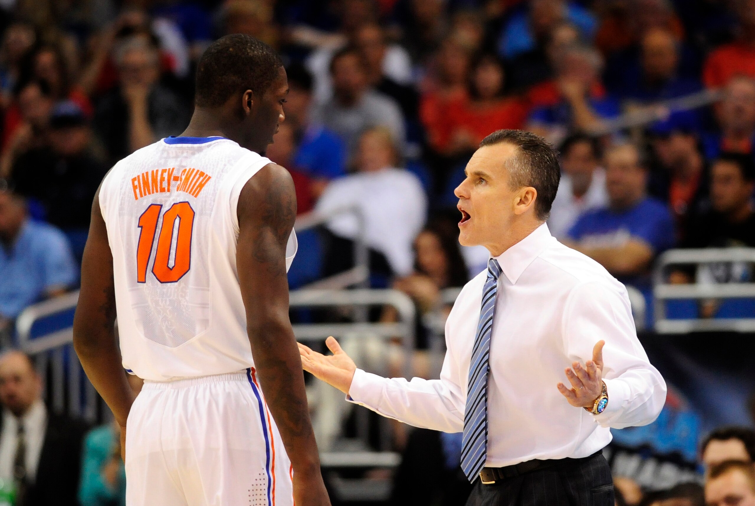 Mar 22, 2014; Orlando, FL, USA; Florida Gators head coach Billy Donovan talks with forward Dorian Finney-Smith (10) in the first half of a men's college basketball game against the Pittsburgh Panthers during the third round of the 2014 NCAA Tournament at