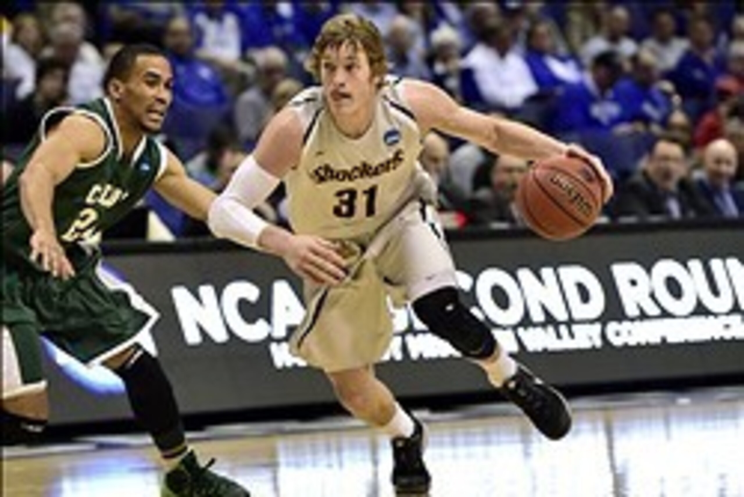 Mar 21, 2014; St. Louis, MO, USA; Wichita State Shockers guard Ron Baker (31) dribbles past Cal Poly Mustangs guard Jamal Johnson (24) in the second half during the 2nd round of the 2014 NCAA Men's  Basketball Championship at Scottrade Center. Mandatory C