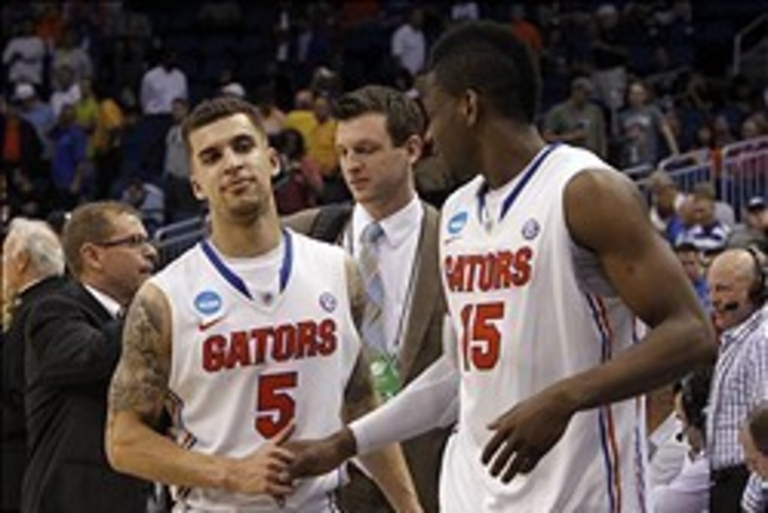 Mar 22, 2014; Orlando, FL, USA; Florida Gators forward Will Yeguete (15) reacts with guard Scottie Wilbekin (5) at the end of the second half of a men's college basketball game against the Pittsburgh Panthers during the third round of the 2014 NCAA Tourna