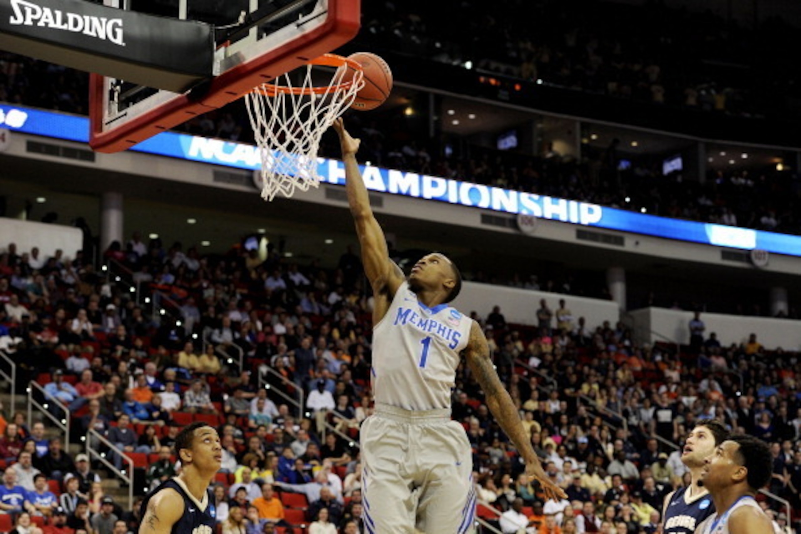 RALEIGH, NC - MARCH 21:  Joe Jackson #1 of the Memphis Tigers shoots over Joe McDonald #22 of the George Washington Colonials in the second half during the Second Round of the 2014 NCAA Basketball Tournament at PNC Arena on March 21, 2014 in Raleigh, Nort
