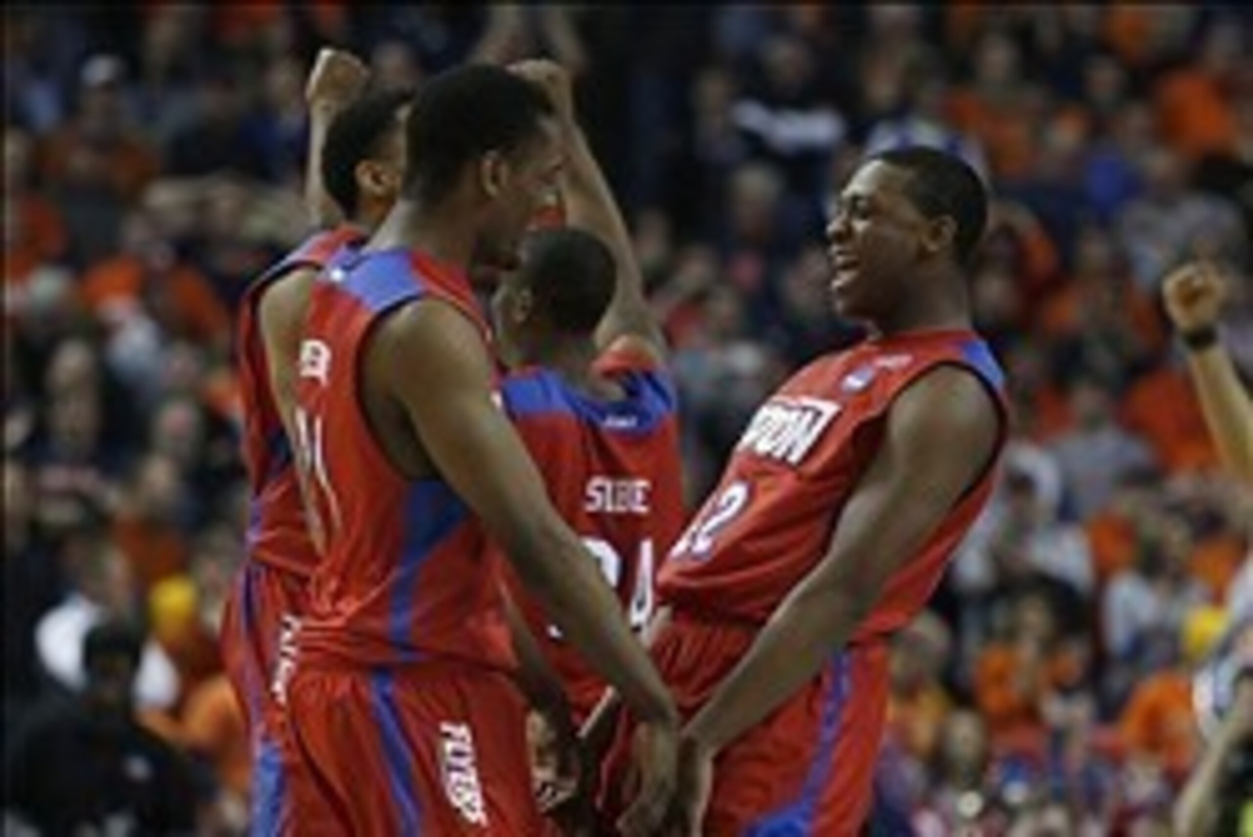 Mar 22, 2014; Buffalo, NY, USA; Dayton Flyers forward Dyshawn Pierre (21) and Dayton Flyers forward Kendall Pollard (22) celebrate beating the Syracuse Orange after a men's college basketball game during the third round of the 2014 NCAA Tournament at Firs