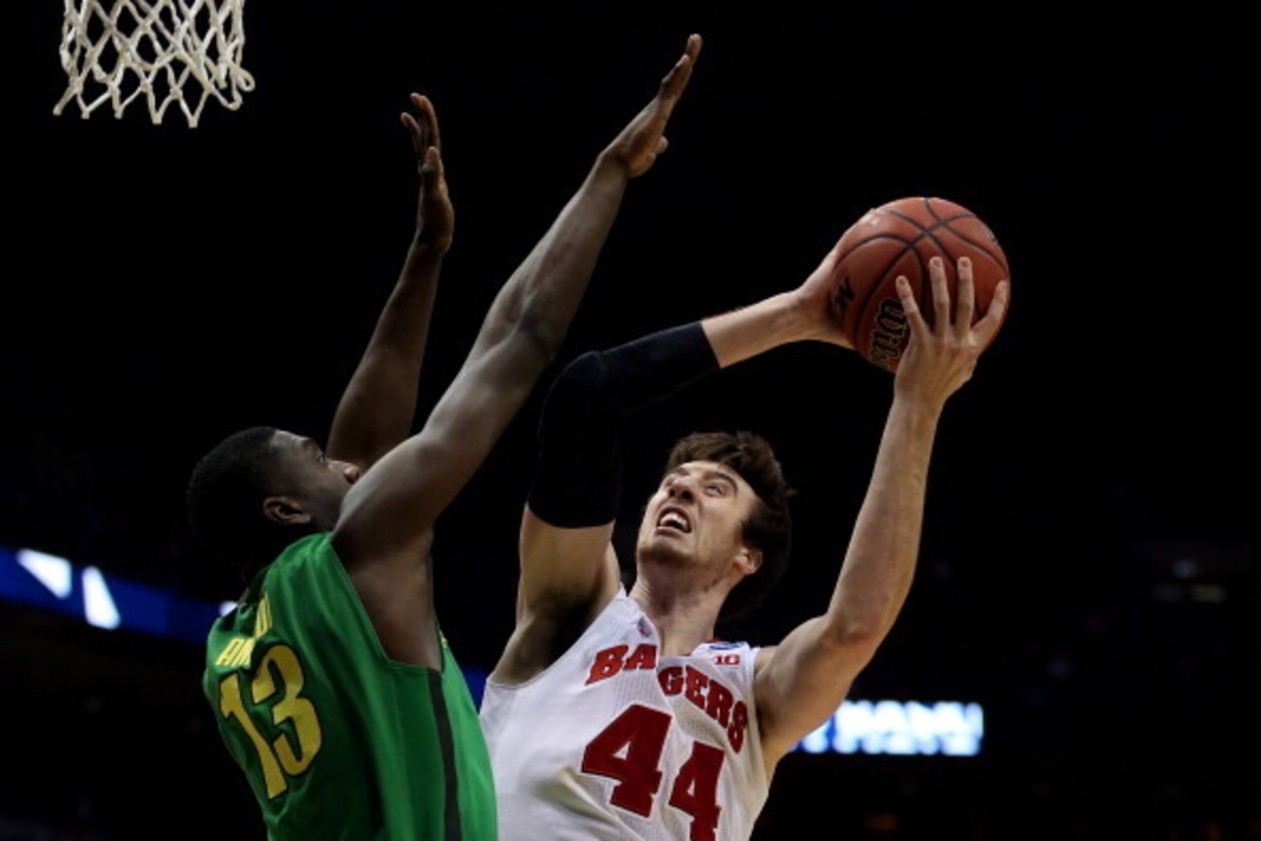 MILWAUKEE, WI - MARCH 22:  Frank Kaminsky #44 of the Wisconsin Badgers shoots the ball against Richard Amardi #13 of the Oregon Ducks during the third round of the 2014 NCAA Men's Basketball Tournament at BMO Harris Bradley Center on March 22, 2014 in Mil