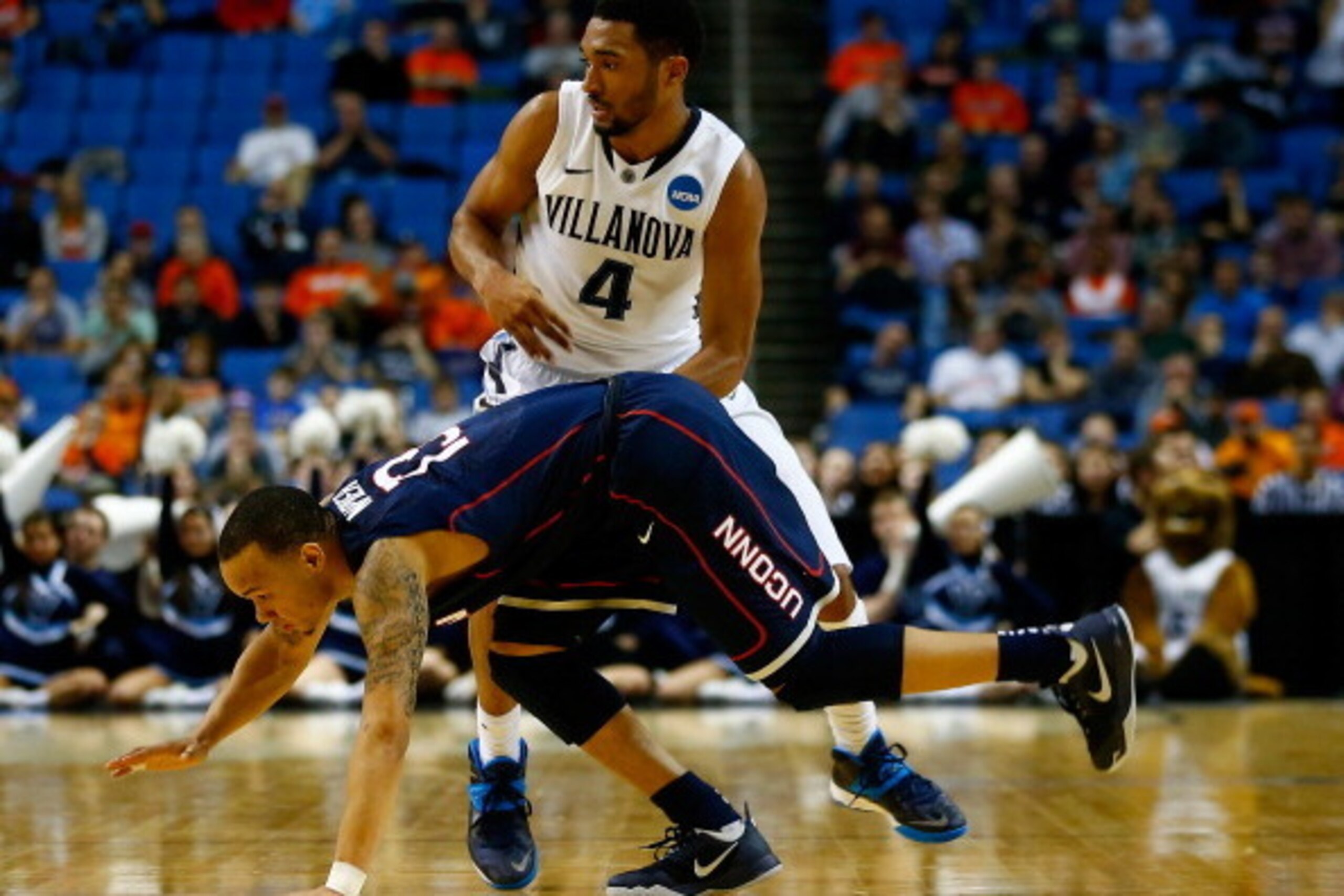 BUFFALO, NY - MARCH 22: Shabazz Napier #13 of the Connecticut Huskies collides with Darrun Hilliard II #4 of the Villanova Wildcats during the third round of the 2014 NCAA Men's Basketball Tournament at the First Niagara Center on March 22, 2014 in Buffal