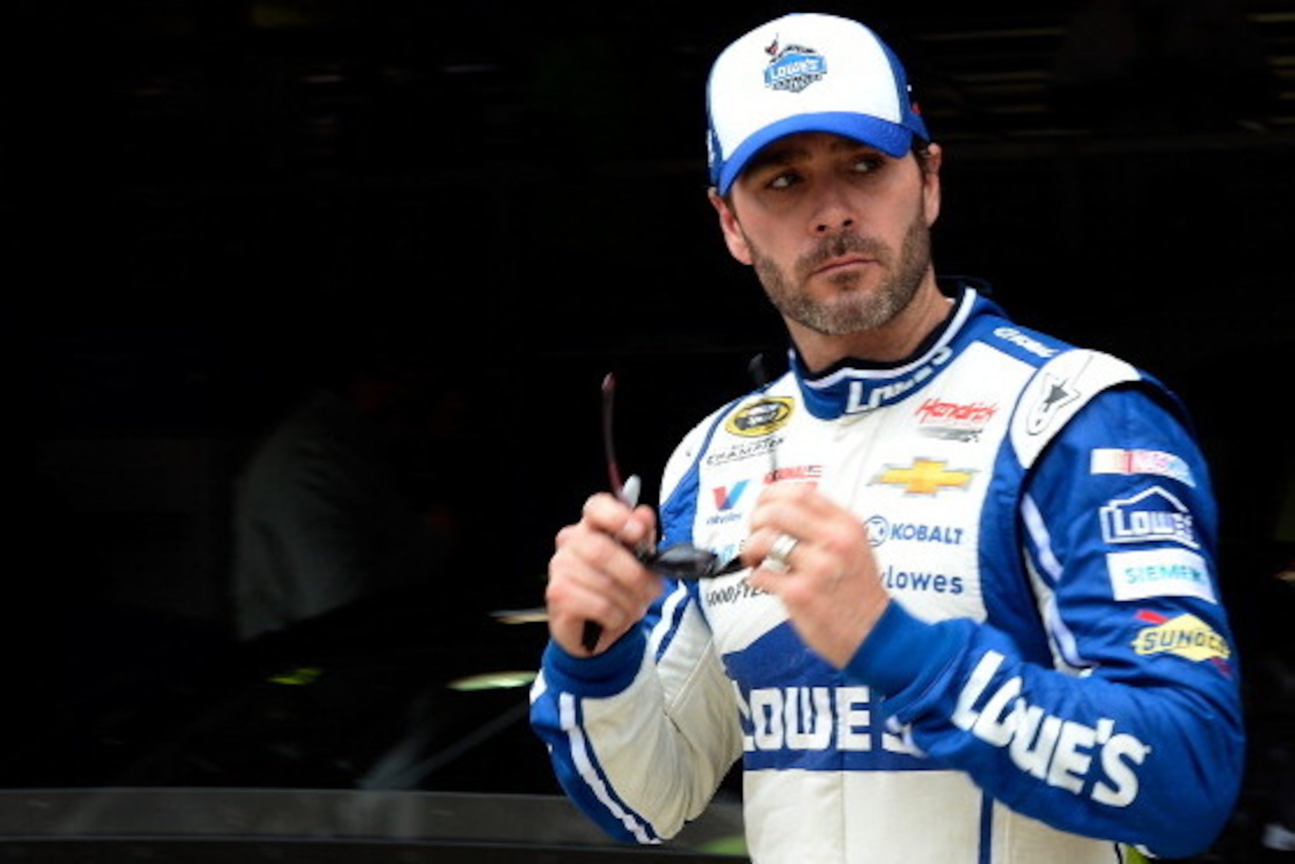 FONTANA, CA - MARCH 22:  Jimmie Johnson, driver of the #48 Lowe's Chevrolet, walks through the garage area during practice for the NASCAR Sprint Cup Series Auto Club 400 at Auto Club Speedway on March 22, 2014 in Fontana, California.  (Photo by Kevork Dja
