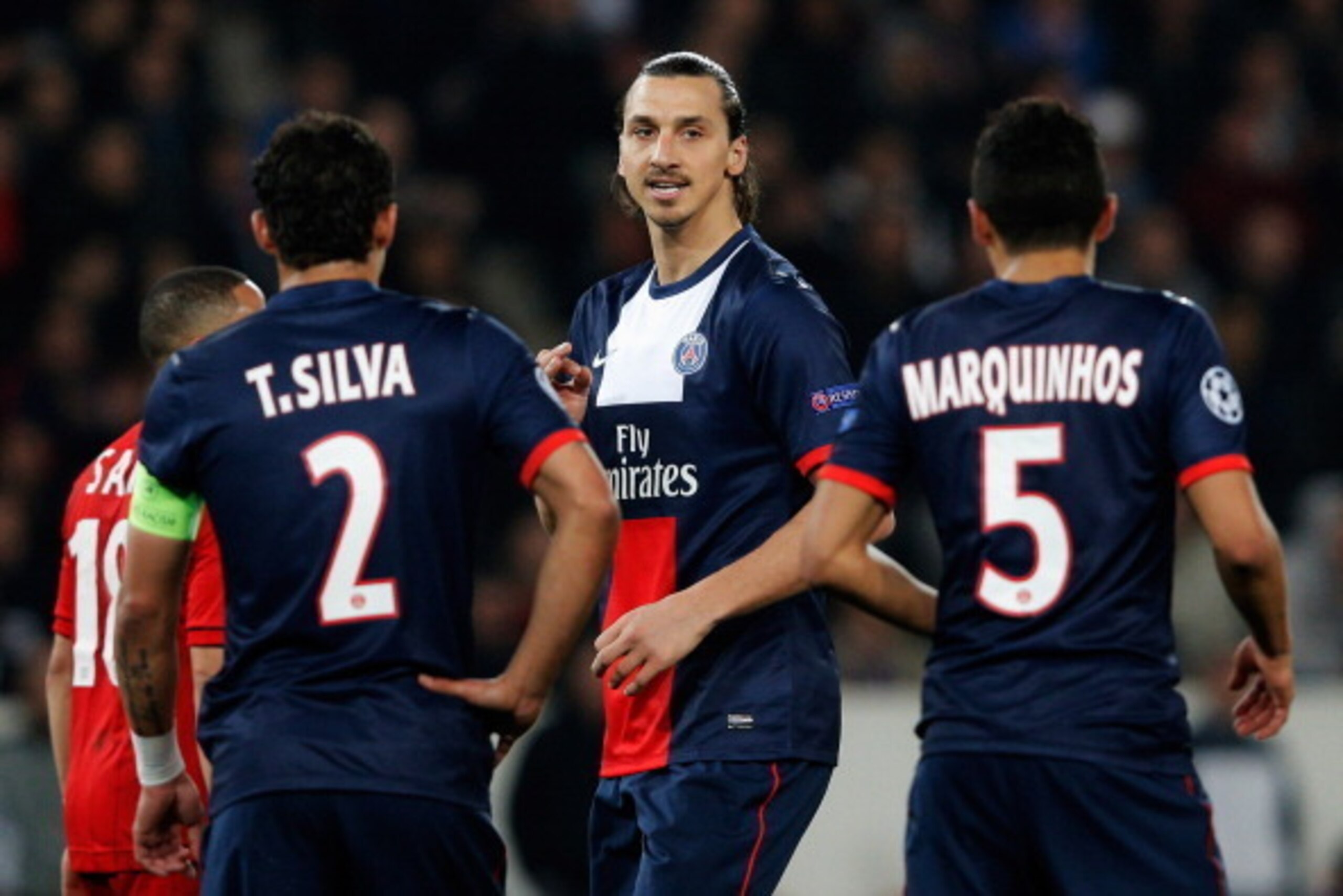 PARIS, FRANCE - MARCH 12:  Zlatan Ibrahimovic (C) of PSG speaks to team mates Thiago Silva and Marquinhos during the UEFA Champions League Round of 16 second leg match between Paris Saint-Germain FC and Bayer Leverkusen at Parc des Princes on March 12, 20