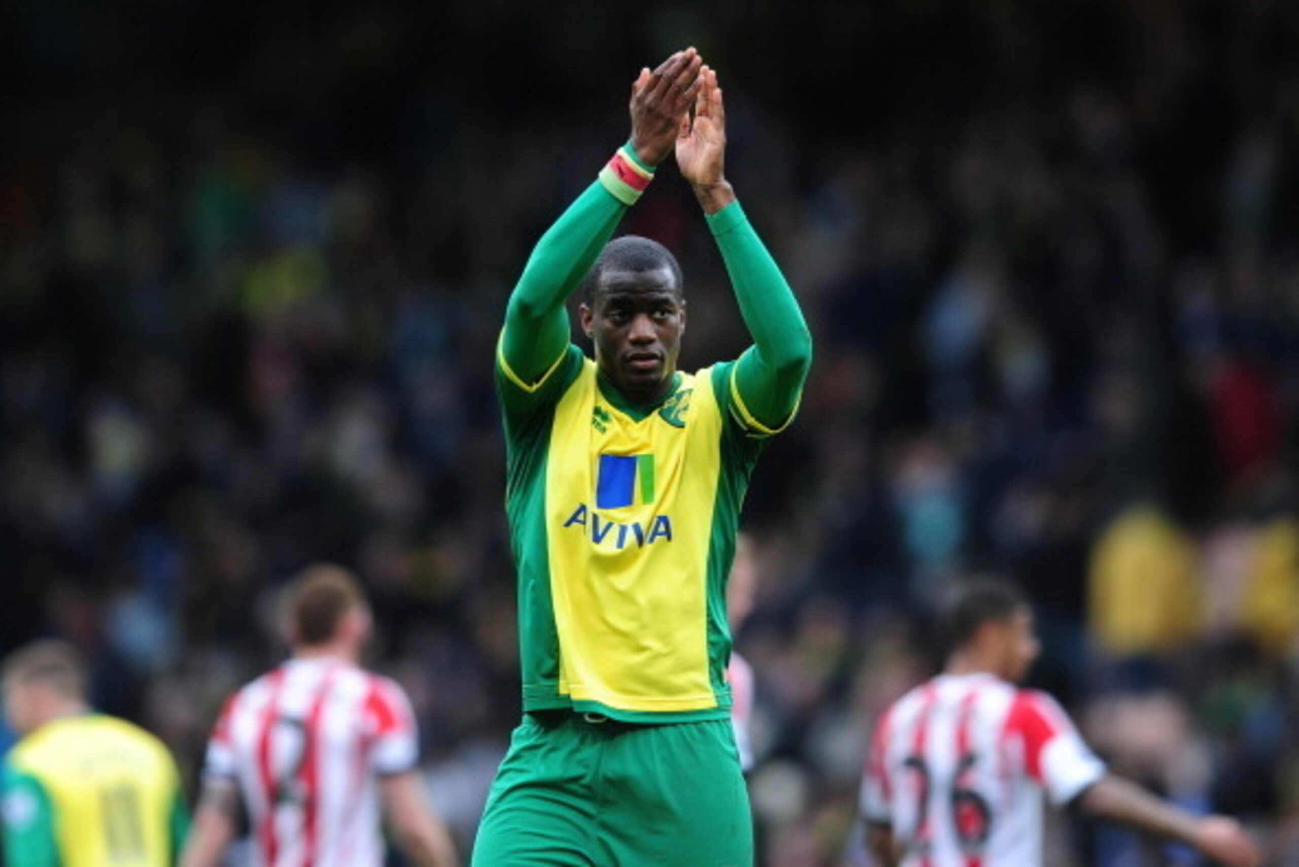 NORWICH, ENGLAND - MARCH 22:  Sebastien Bassong of Norwich City applauds the Norwich fans after the Barclays Premier League match between Norwich City and Sunderland at Carrow Road on March 22, 2014 in Norwich, England. (Photo by Alex Broadway/Getty Image