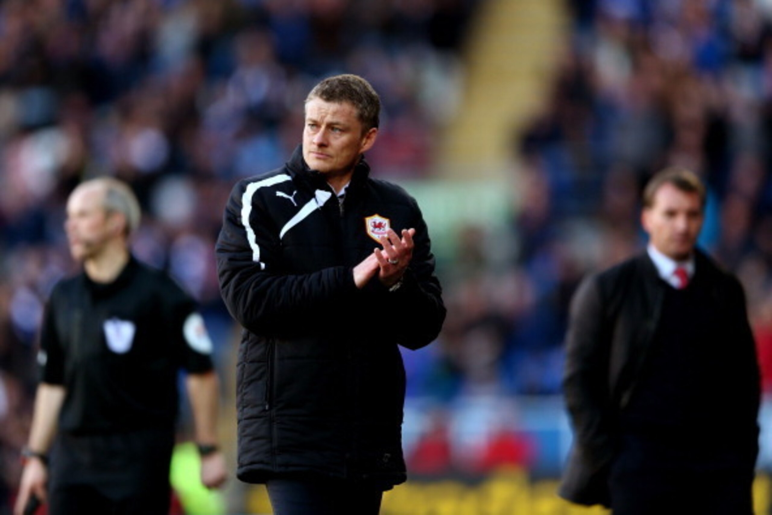 CARDIFF, WALES - MARCH 22:  (L-R) Ole Gunnar Solskjaer the Cardiff City manager reacts as Brendan Rodgers the Liverpool manager looks on  following his team's 6-3 defeat during the Barclays Premier League match between Cardiff City and Liverpool at Cardif