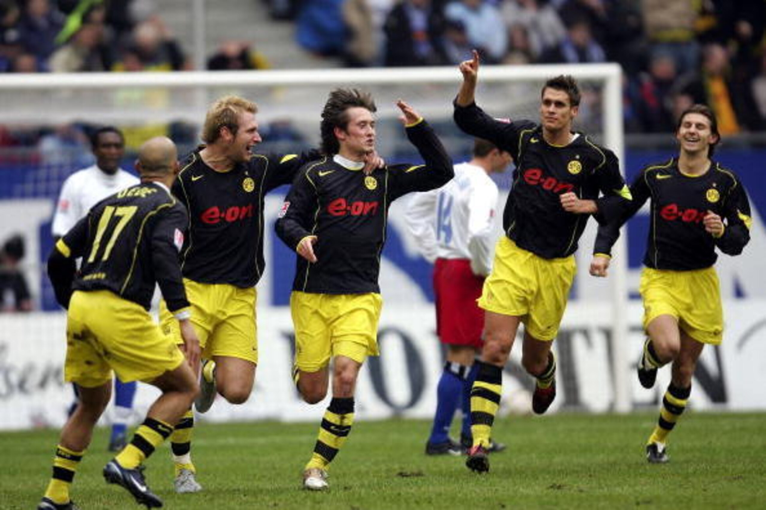 HAMBURG, GERMANY - MARCH 19: Tomas Rosicky (c) celebrates scoring the first goal with Dede, Florian Kringe and Sebastien Kehl of Dortmund during The Bundesliga Match between Hamburg SV and  Borussia Dortmund, at The AOL Arena  on March 19, 2005 in Hamburg
