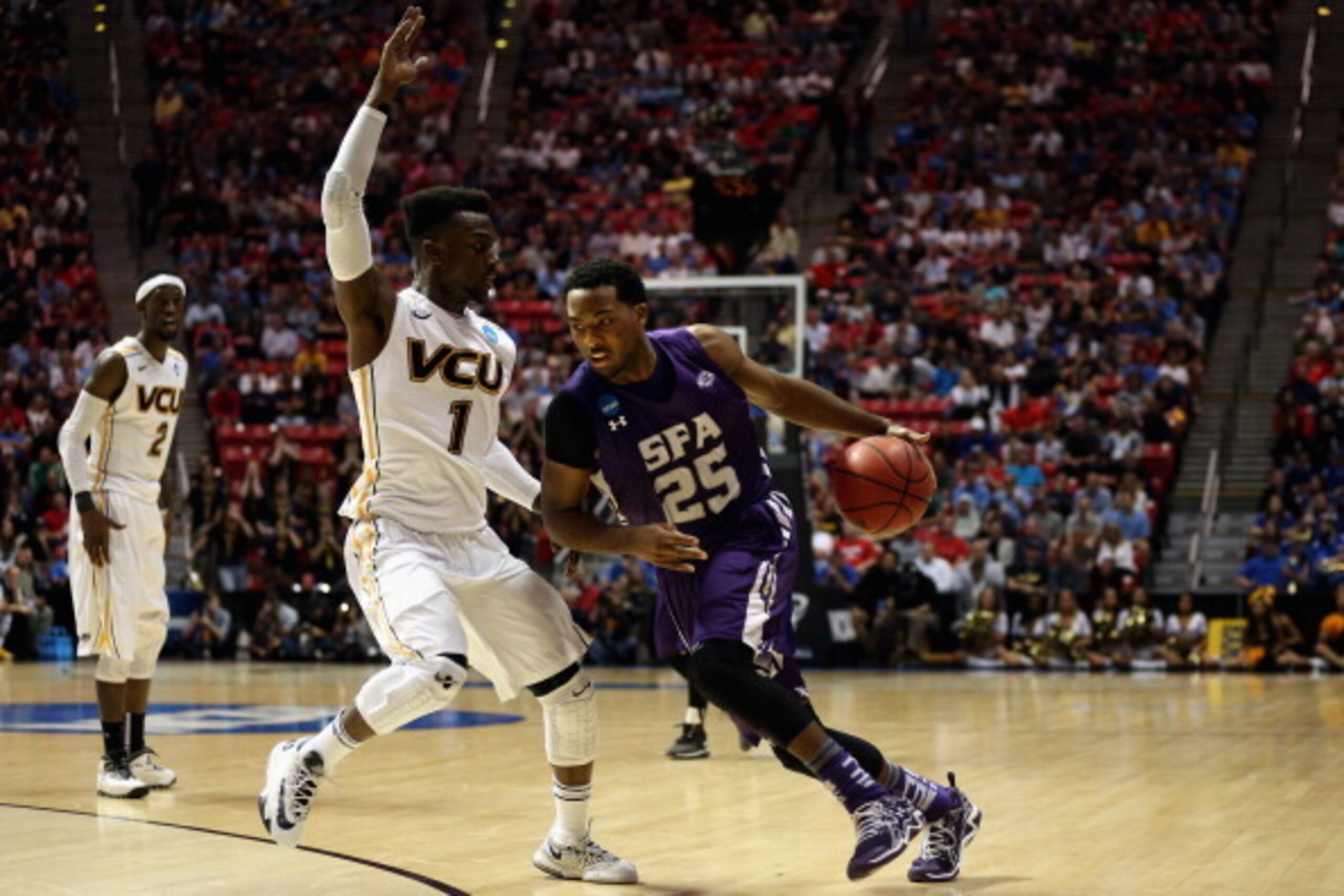 SAN DIEGO, CA - MARCH 21: Desmond Haymon #25 of the Stephen F. Austin Lumberjacks drives the ball around JeQuan Lewis #1 of the Virginia Commonwealth Rams during the second round of the 2014 NCAA Men's Basketball Tournament at Viejas Arena on March 21, 2 SAN DIEGO, CA - MARCH 21: Desmond Haymon #25 of the Stephen F. Austin Lumberjacks drives the ball around JeQuan Lewis #1 of the Virginia Commonwealth Rams during the second round of the 2014 NCAA Men's Basketball Tournament at Viejas Arena on March 21, 2