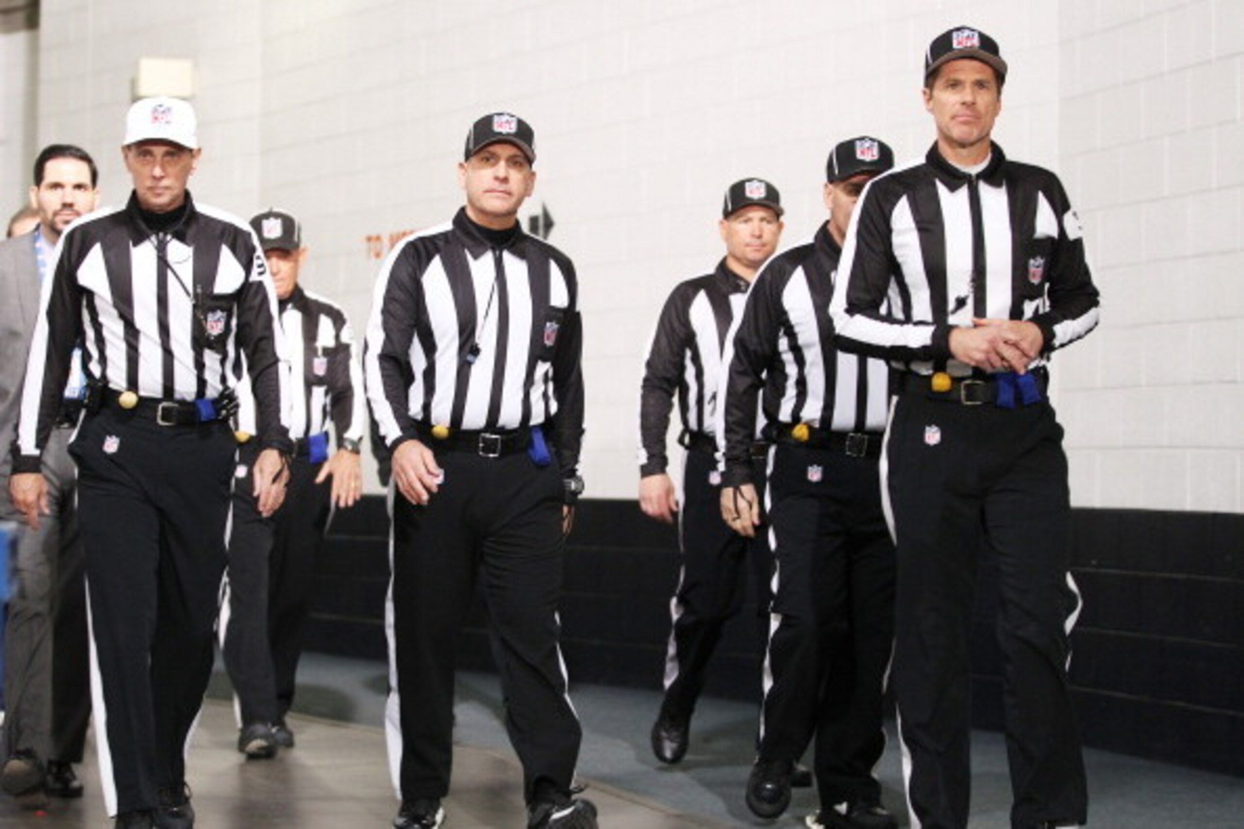 DENVER, CO - JANUARY 19:  NFL referees walk in the stadium prior to the AFC Championship game between the Denver Broncos and the New England Patriots at Sports Authority Field at Mile High on January 19, 2014 in Denver, Colorado.  (Photo by Doug Pensinger