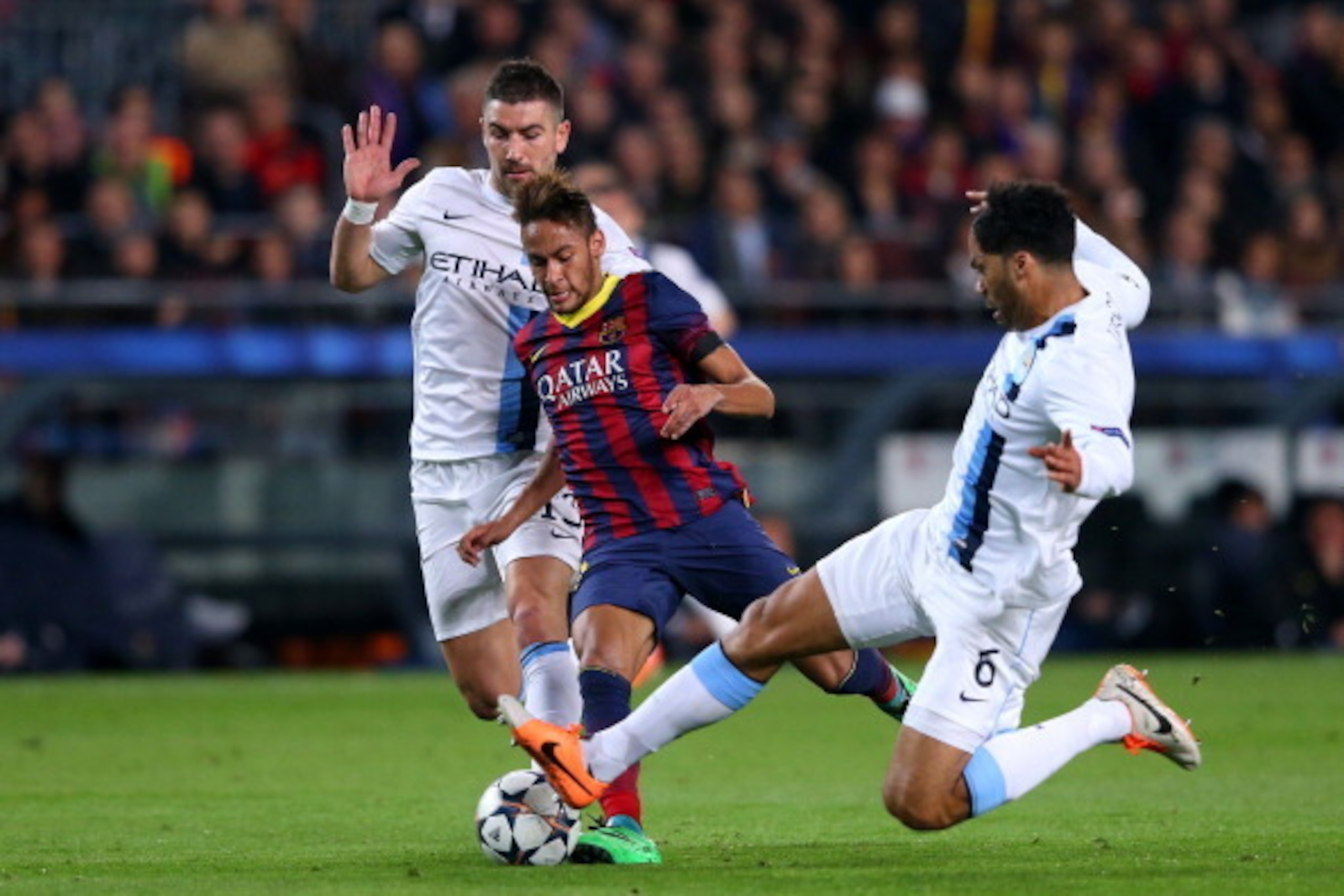 BARCELONA, SPAIN - MARCH 12:  Neymar (C) of Barcelona is tackled by Joleon Lescott (R) and Aleksandar Kolarov (L) of Manchester City during the UEFA Champions League Round of 16, second leg match between FC Barcelona and Manchester City  at Camp Nou on Ma