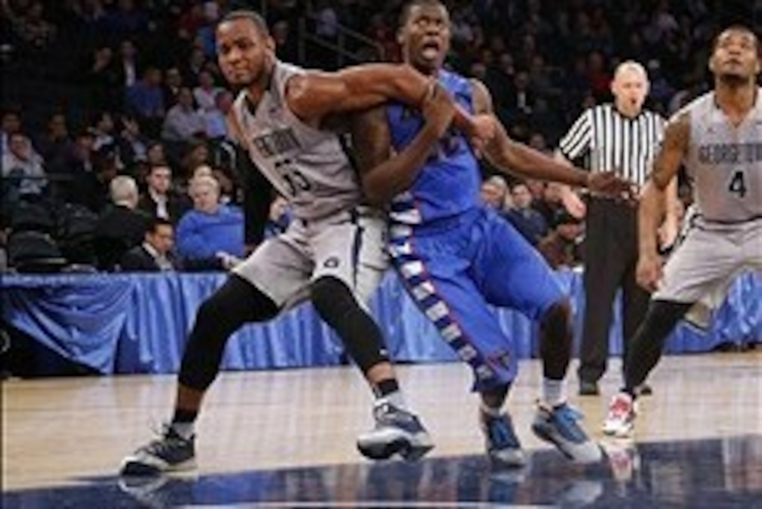 Mar 12, 2014; New York, NY, USA; Georgetown Hoyas guard Jabril Trawick (55) battles for position with DePaul Blue Demons guard Charles McKinney (32) during the first half in the first round of the Big East tournament at Madison Square Garden. Mandatory Cr