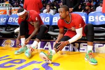 LOS ANGELES, CA - DECEMBER 25: LeBron James #6 and Dwyane Wade #3 of the Miami Heat tie their shoes during a game against the Los Angeles Lakers at STAPLES Center on December 25, 2013 in Los Angeles, California. NOTE TO USER: User expressly acknowledges a