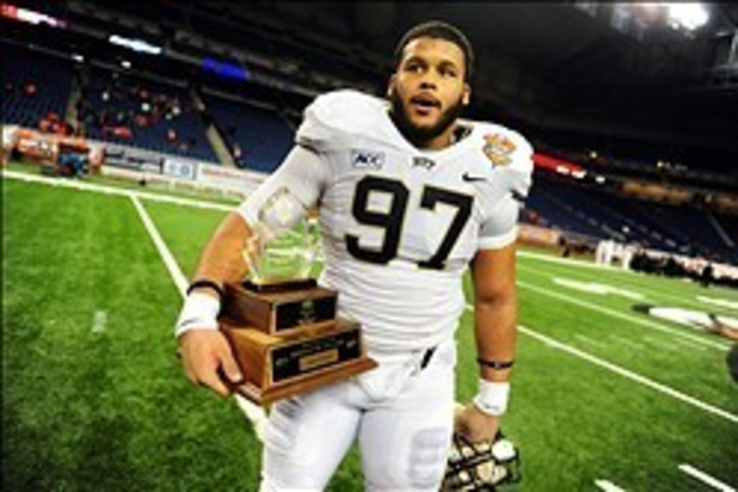 Dec 26, 2013; Detroit, MI, USA; Pittsburgh Panthers defensive lineman Aaron Donald (97) holds the lineman of the game trophy after defeating Bowling Green Falcons 30-27 to win the Little Caesars Pizza Bowl at Ford Field. Mandatory Credit: Andrew Weber-USA
