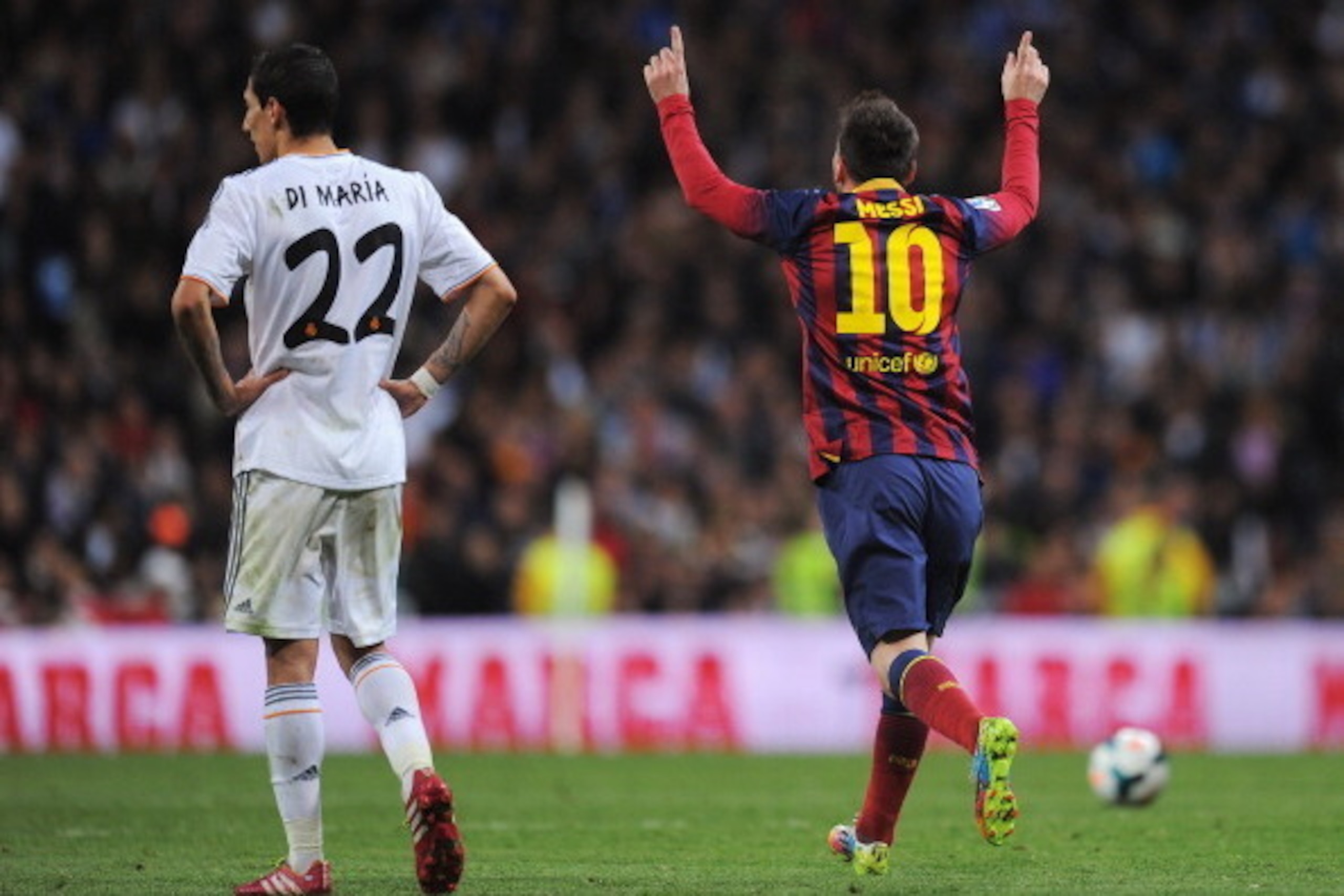 MADRID, SPAIN - MARCH 23:  Lionel Messi of Barcelona celebrates scoring his team's third goal as Angel Di Maria of Real Madrid looks on during the La Liga match between Real Madrid CF and FC Barcelona at the Bernabeu on March 23, 2014 in Madrid, Spain.  (