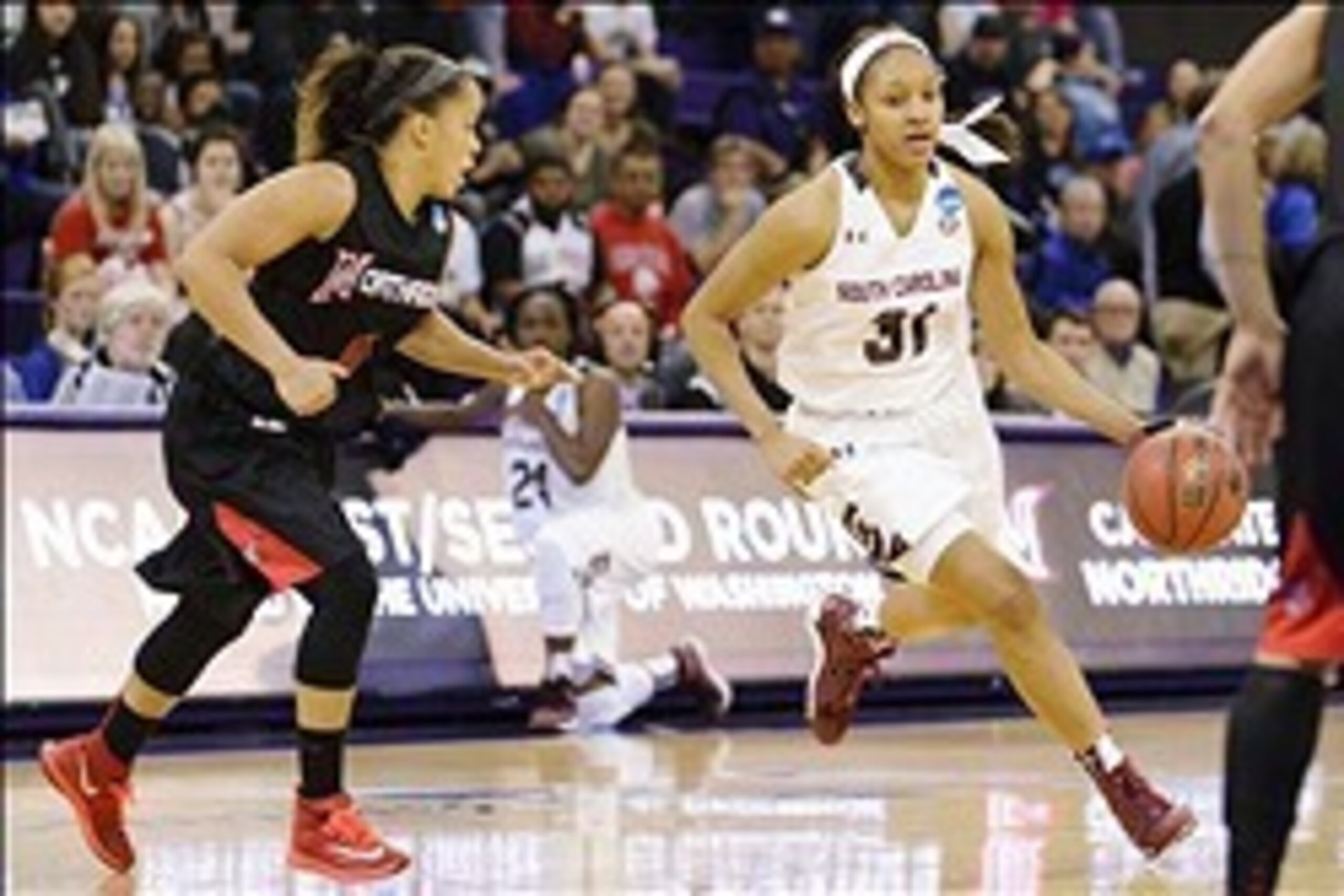 Mar 23, 2014; Seattle, WA, USA; South Carolina Gamecocks guard Asia Dozier (31) dribbles towards the basket while being defended by Cal State Northridge Matadors guard Cinnamon Lister (11) in the second half of a women's college basketball game in the fir