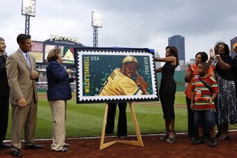 PITTSBURGH, PA - JULY 21: Members of the Pittsburgh Pirates organization and family members of former player Willie Stargell unveil a commemorative stamp issued by the United States Postal Service prior to the game against the Miami Marlins at PNC Park on