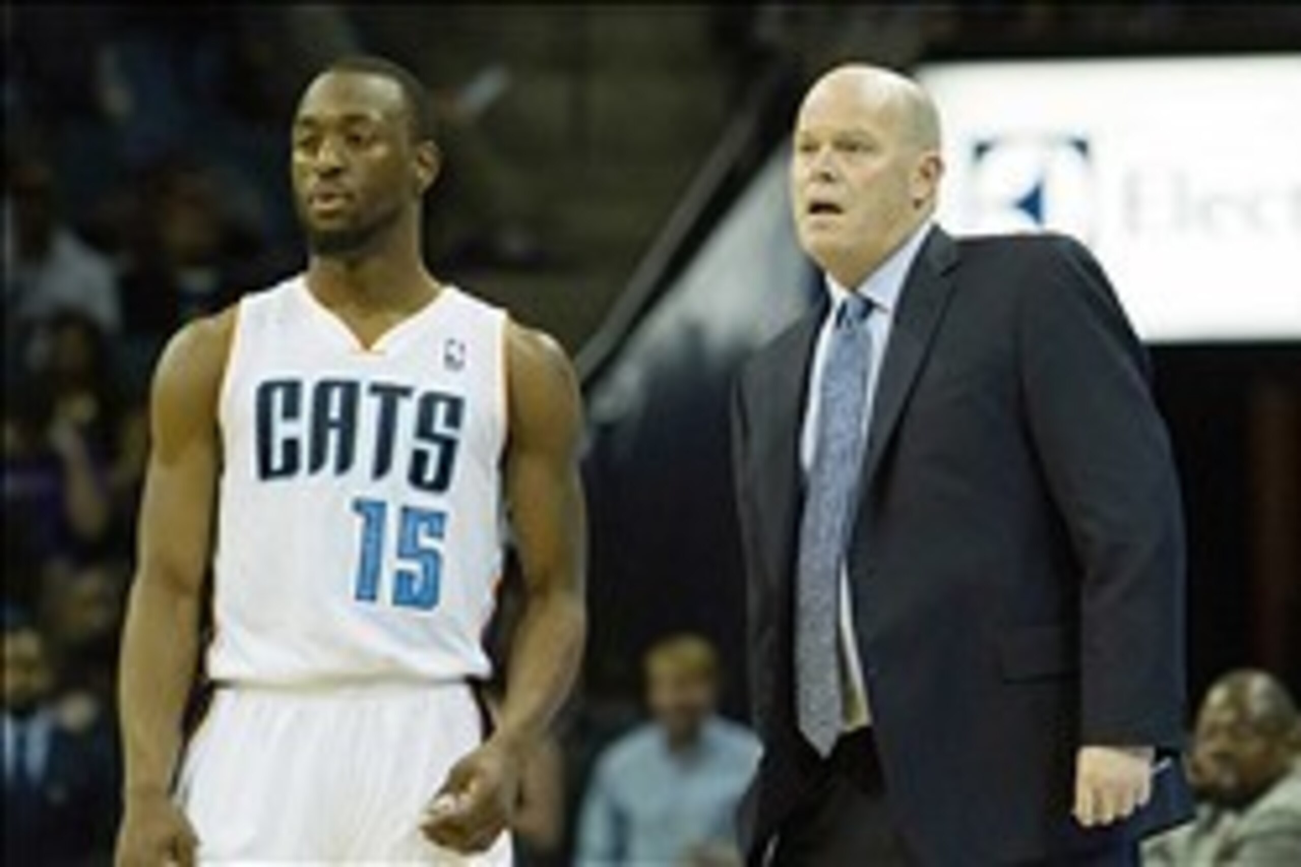 Mar 22, 2014; Charlotte, NC, USA; Charlotte Bobcats head coach Steve Clifford talks with guard Kemba Walker (15) during the first half against the Portland Trail Blazers at Time Warner Cable Arena. Mandatory Credit: Jeremy Brevard-USA TODAY Sports