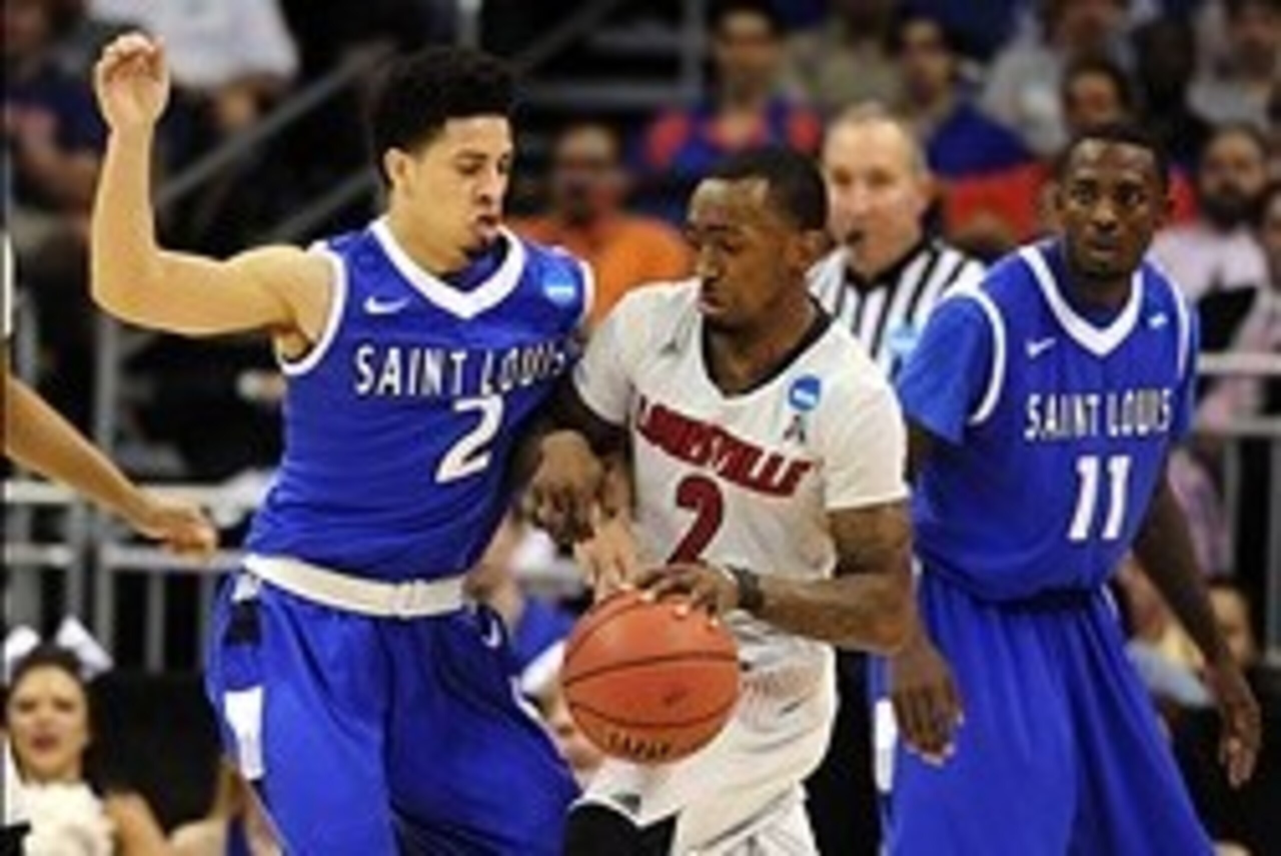 Mar 22, 2014; Orlando, FL, USA; Louisville Cardinals guard Russ Smith (2) drives against Saint Louis Billikens guard Austin McBroom (2) in the first half of a men's college basketball game during the third round of the 2014 NCAA Tournament at Amway Center