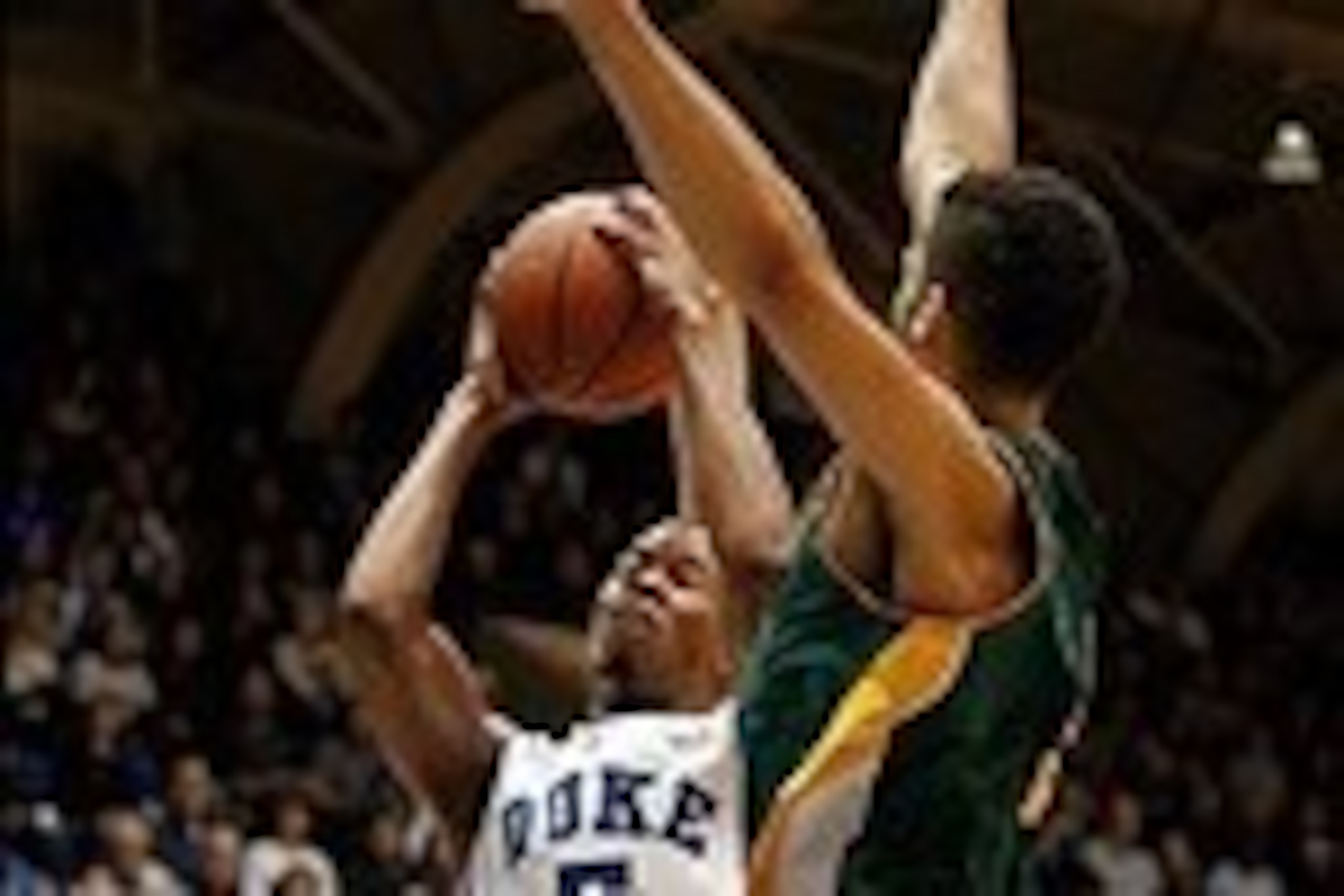 Nov 24, 2013; Durham, NC, USA; Duke Blue Devils forward Rodney Hood (5) shoots as Vermont Catamounts forward Hector Harold (5) defends at Cameron Indoor Stadium. Mandatory Credit: Mark Dolejs-USA TODAY Sports