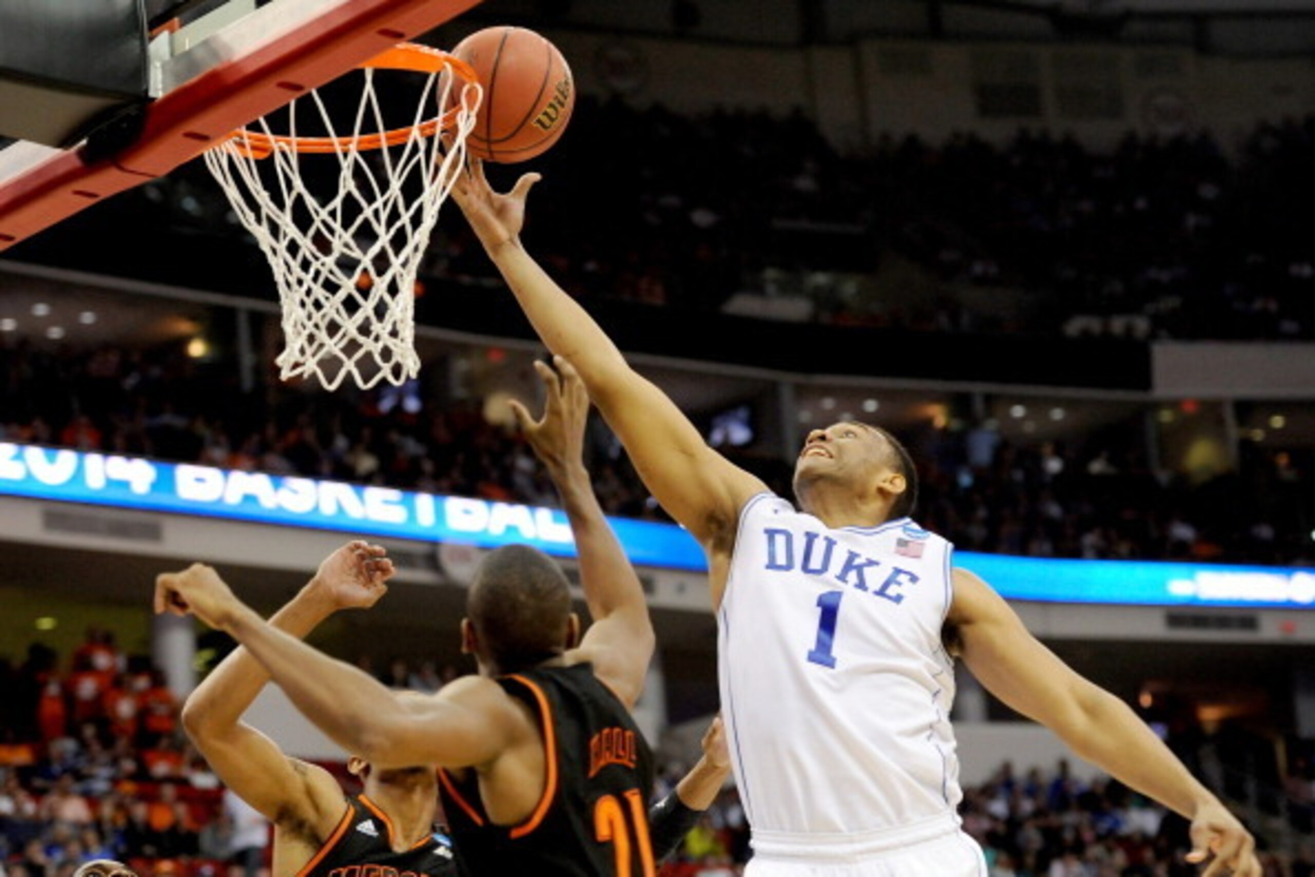 RALEIGH, NC - MARCH 21:  Jabari Parker #1 of the Duke Blue Devils goes up for the ball against Langston Hall #21 of the Mercer Bears in the first half in the second round of the 2014 NCAA Men's Basketball Tournament at PNC Arena on March 21, 2014 in Ralei