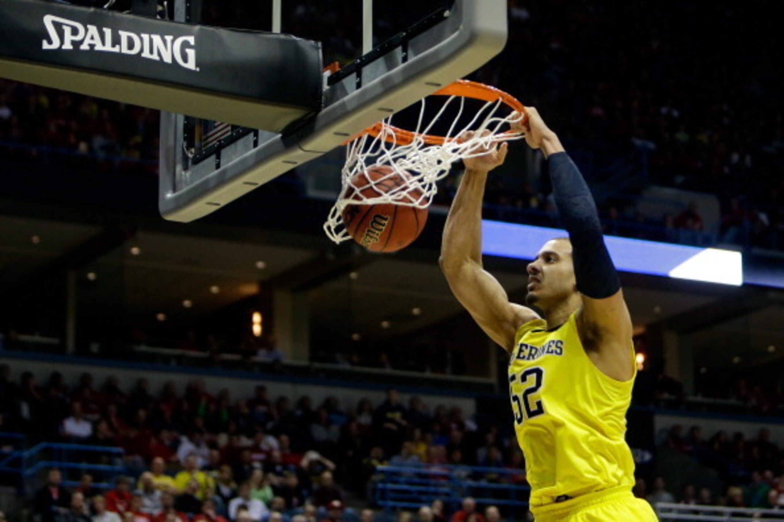 MILWAUKEE, WI - MARCH 22:  Jordan Morgan #52 of the Michigan Wolverines dunks the ball against the Texas Longhorns during the third round of the 2014 NCAA Men's Basketball Tournament at BMO Harris Bradley Center on March 22, 2014 in Milwaukee, Wisconsin. 