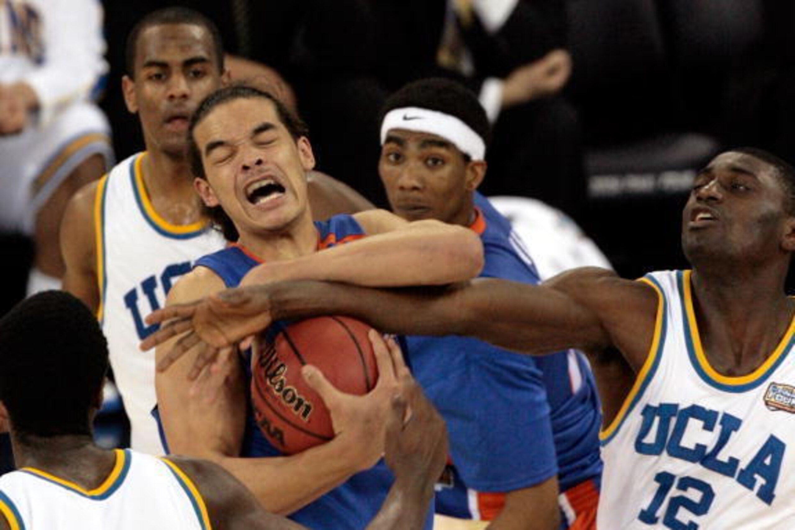 INDIANAPOLIS - APRIL 03: Joakim Noah #13 of the Florida Gators protects the ball from Alfred Aboya #12 of the UCLA Bruins during the National Championship game of the NCAA Men's Final Four on April 3, 2006 at the RCA Dome in Indianapolis, Indiana. The Ga INDIANAPOLIS - APRIL 03: Joakim Noah #13 of the Florida Gators protects the ball from Alfred Aboya #12 of the UCLA Bruins during the National Championship game of the NCAA Men's Final Four on April 3, 2006 at the RCA Dome in Indianapolis, Indiana. The Ga