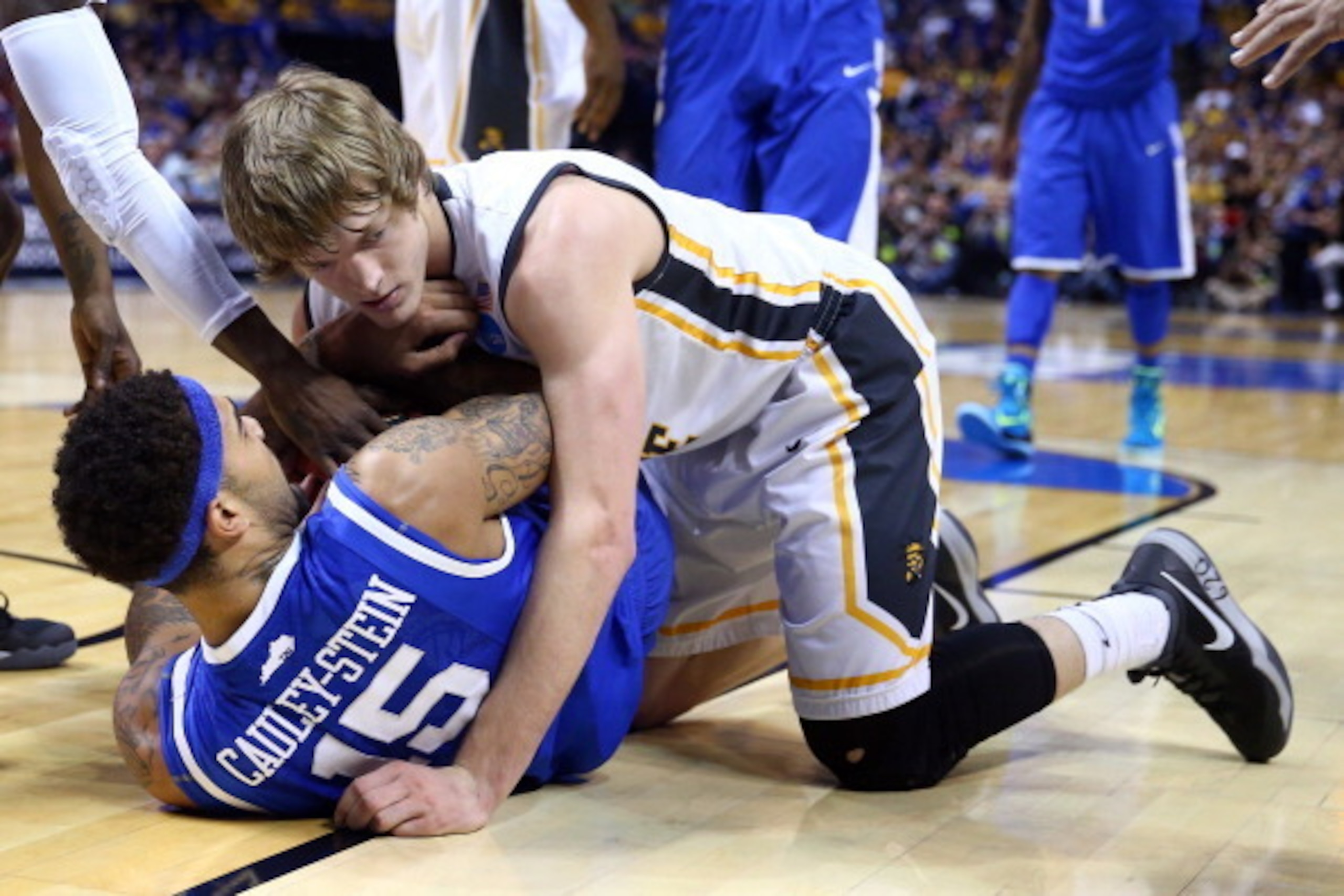 ST LOUIS, MO - MARCH 23:  wRon Baker #31 of the Wichita State Shockers falls on top of Willie Cauley-Stein #15 of the Kentucky Wildcats during the third round of the 2014 NCAA Men's Basketball Tournament at Scottrade Center on March 23, 2014 in St Louis, 