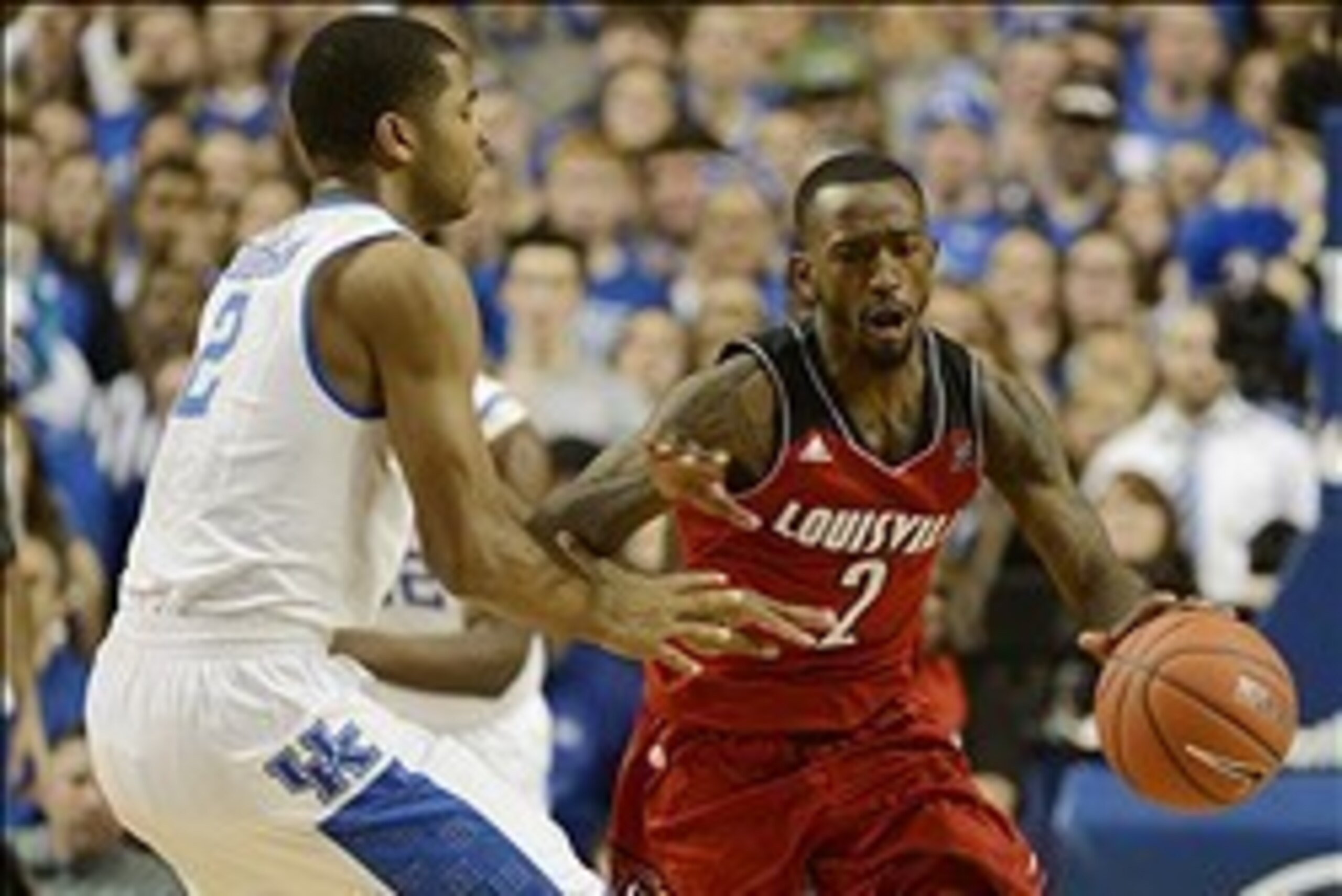 Dec 28, 2013; Lexington, KY, USA; Louisville Cardinals guard Russ Smith (2) dribbles against Kentucky Wildcats guard Aaron Harrison (2) during the second half at Rupp Arena. Kentucky defeated Louisville 73-66.  Mandatory Credit: Jamie Rhodes-USA TODAY Spo