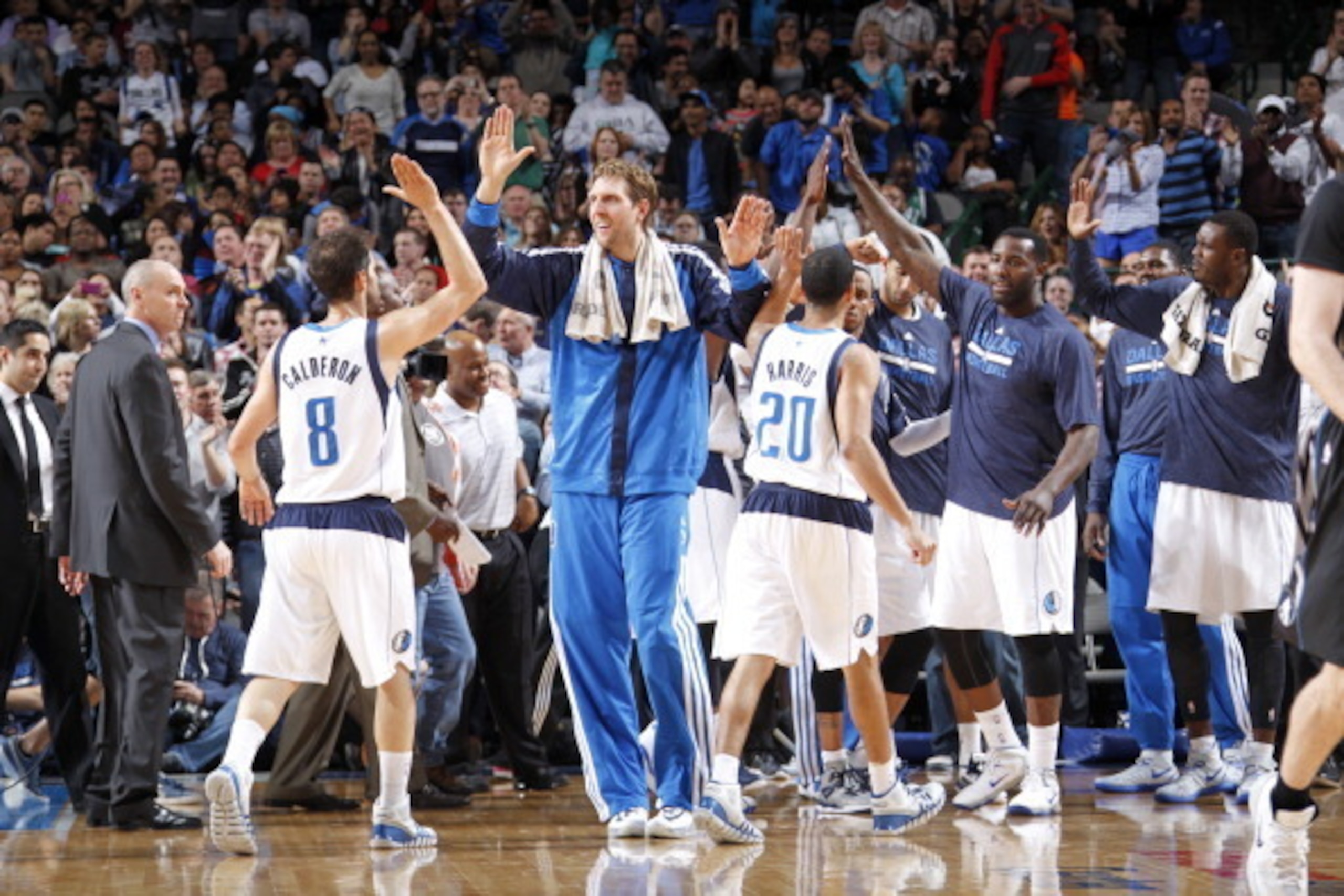 DALLAS, TX - MARCH 19: Dirk Nowitzki #41 and the Dallas Mavericks celebrate during a timeout against the Minnesota Timberwolves on March 19, 2014 at the American Airlines Center in Dallas, Texas. NOTE TO USER: User expressly acknowledges and agrees that, 