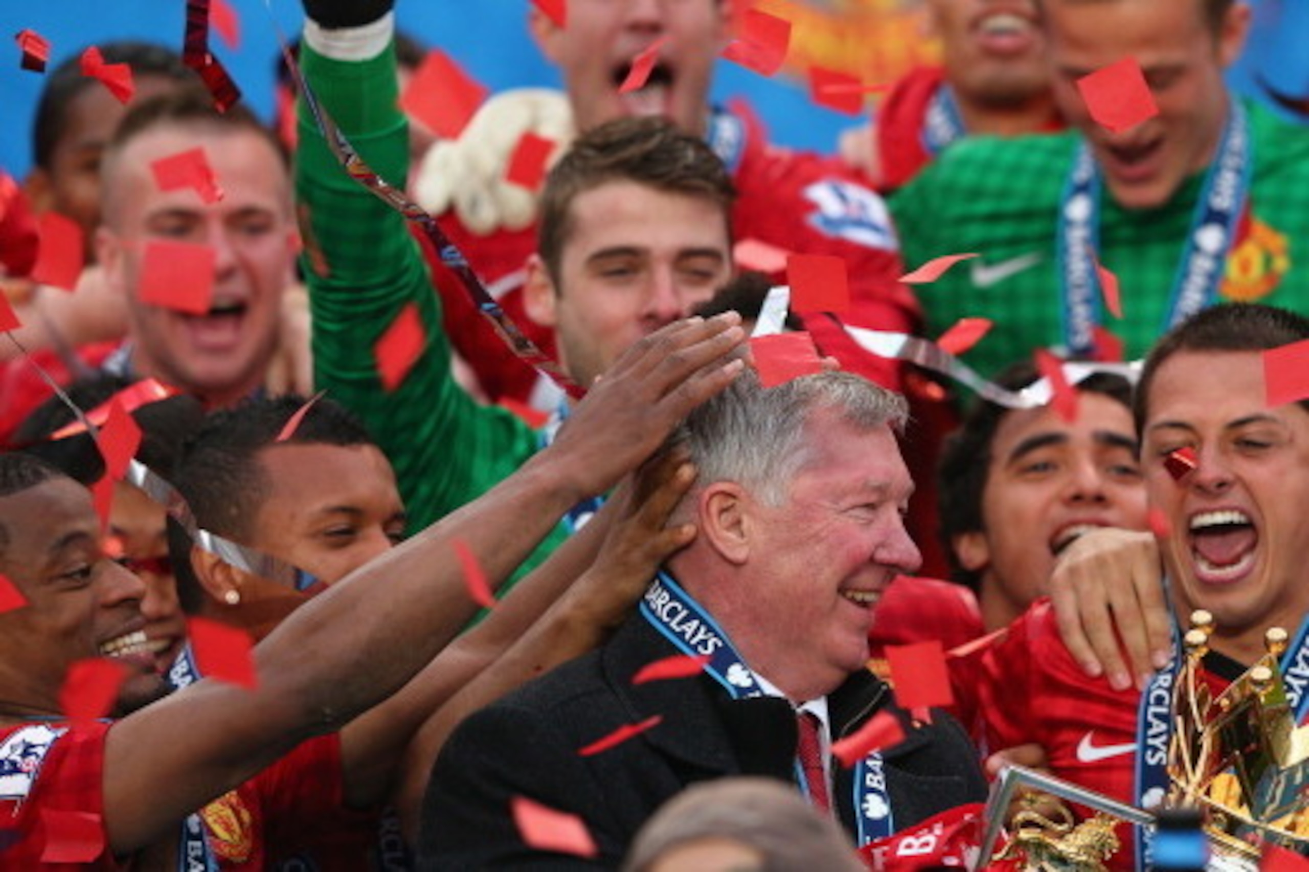 MANCHESTER, ENGLAND - MAY 12:  Manchester United Manager Sir Alex Ferguson celebrates with his players and the Premier League trophy following the Barclays Premier League match between Manchester United and Swansea City at Old Trafford on May 12, 2013 in 