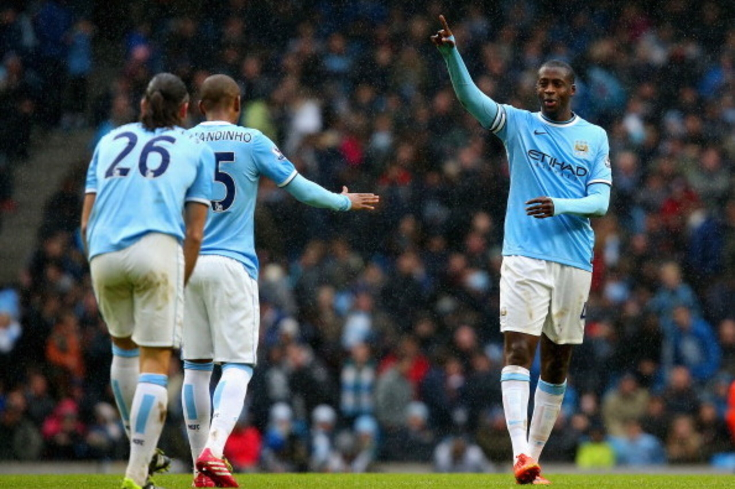 MANCHESTER, ENGLAND - MARCH 22:  Yaya Toure of Manchester City celebrates scoring their second goal with Fernandinho of Manchester City during the Barclays Premier League match between Manchester City and Fulham at Etihad Stadium on March 22, 2014 in Manc