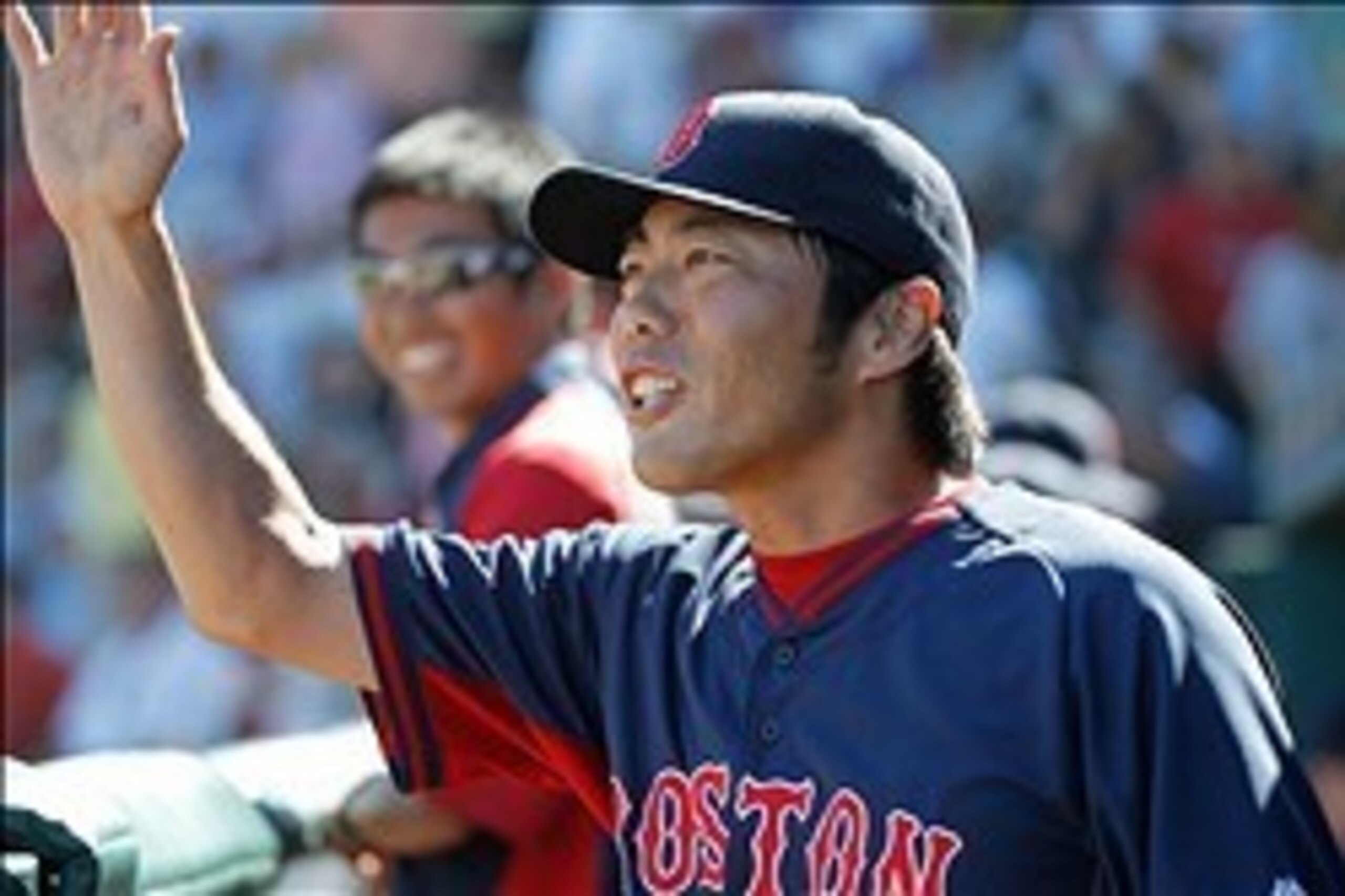 Mar 3, 2014; Bradenton, FL, USA; Boston Red Sox relief pitcher Koji Uehara (19) high fives teammates after he pitched the fourth inning against the Pittsburgh Pirates at McKechnie Field. Mandatory Credit: Kim Klement-USA TODAY Sports