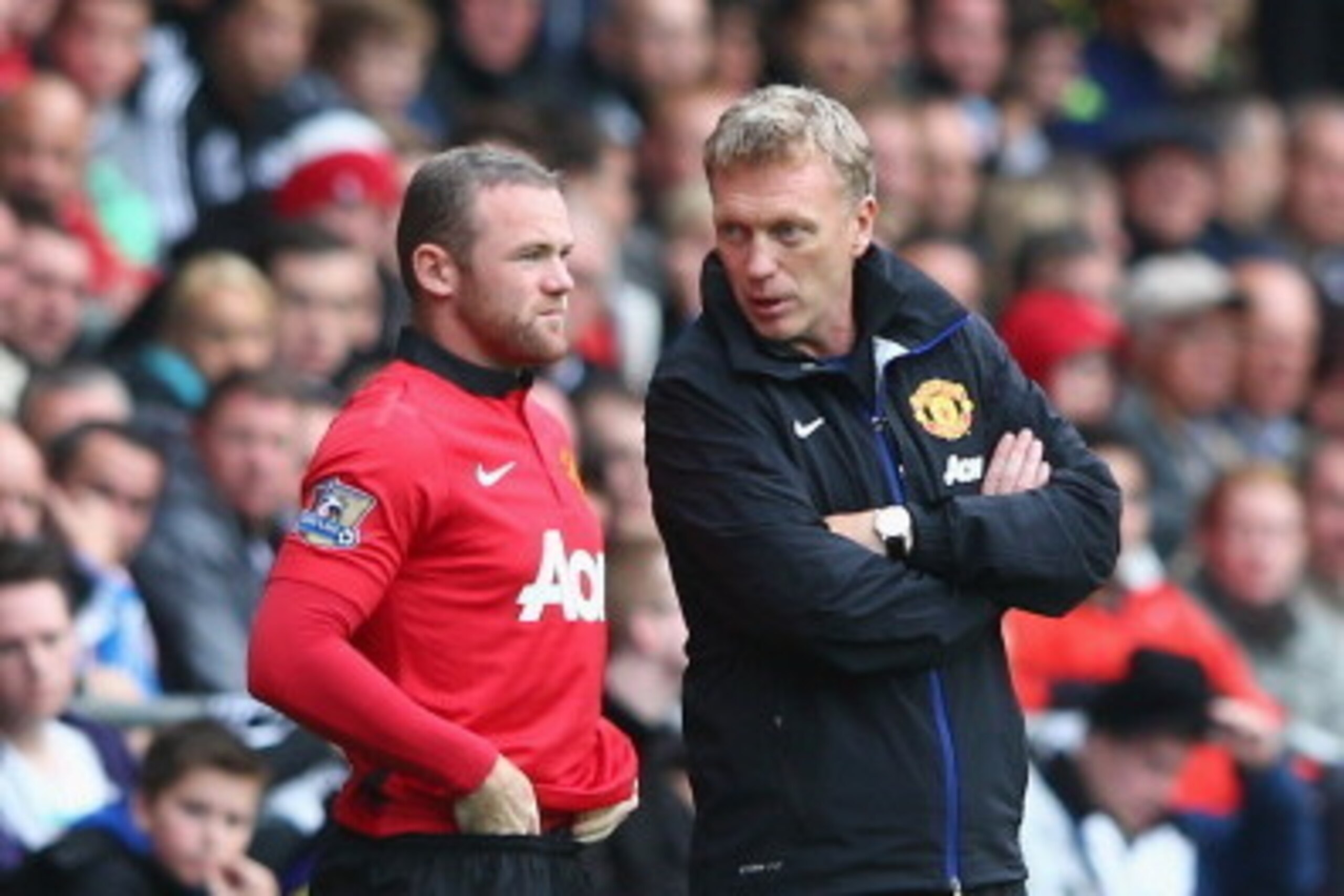 SWANSEA, WALES - AUGUST 17: David Moyes (R) the manager of Manchester United passes on final instructions as Wayne Rooney (L) comes on as a substitute during the Barclays Premier League match between Swansea City and Manchester United at the Liberty Stadi