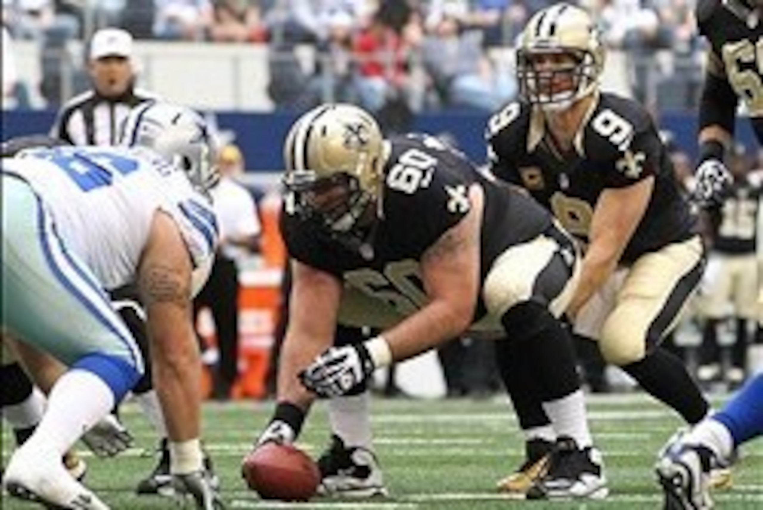 Dec 23, 2012; Arlington, TX, USA; New Orleans Saints quarterback Drew Brees (9) under center with Brian de la Puente (60) during the first half of the game against the Dallas Cowboys at Cowboys Stadium. The Saints beat the Cowboys 34-31 in overtime. Manda