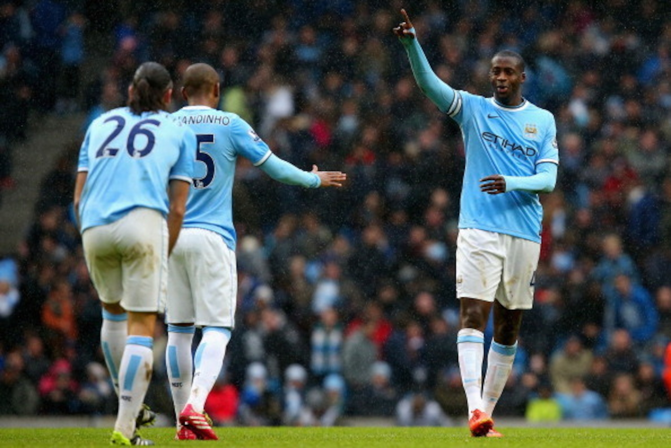 MANCHESTER, ENGLAND - MARCH 22:  Yaya Toure of Manchester City celebrates scoring their second goal with Fernandinho of Manchester City during the Barclays Premier League match between Manchester City and Fulham at Etihad Stadium on March 22, 2014 in Manc